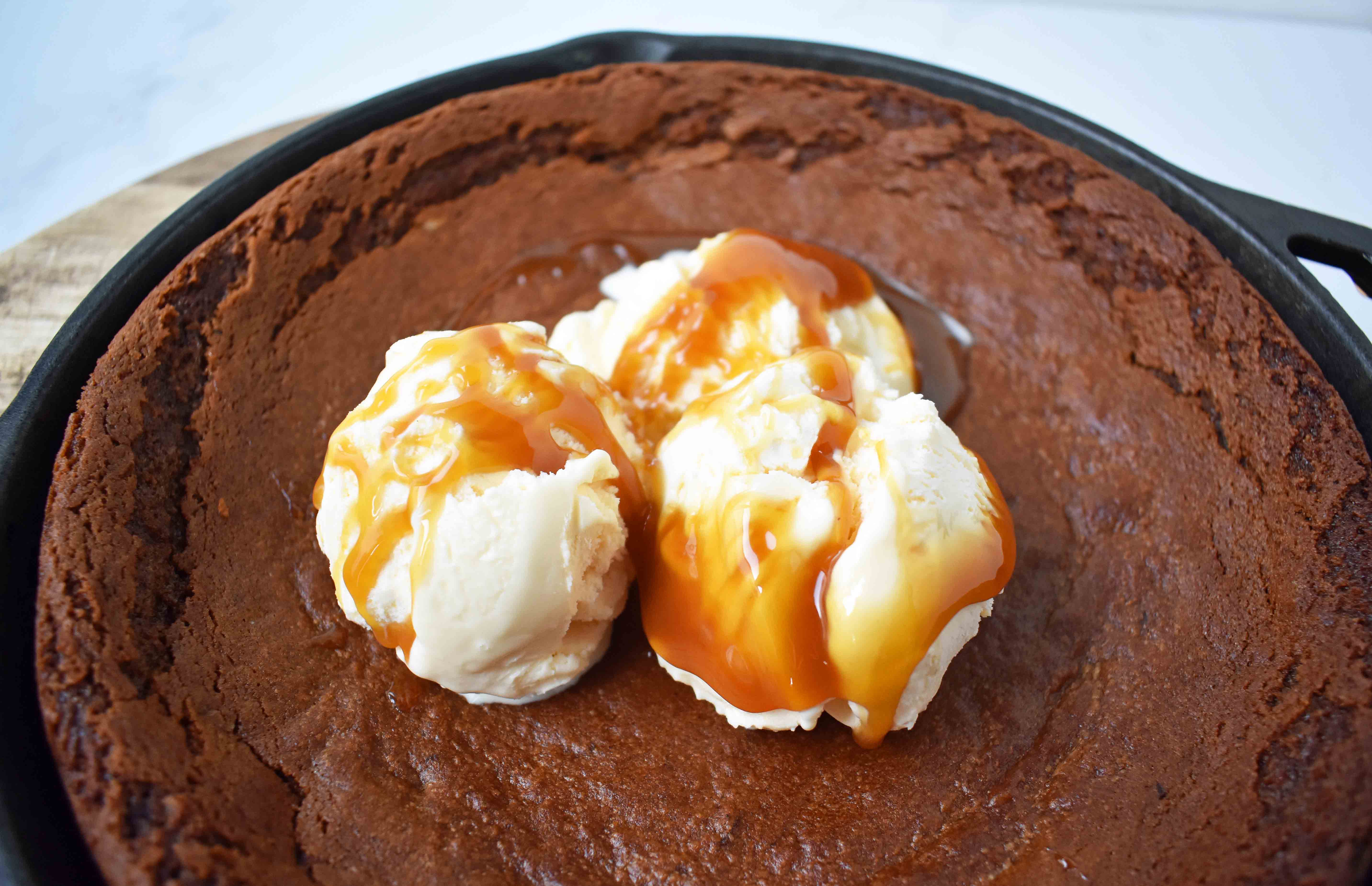 Gingerbread Skillet Cookie with Caramel Sauce by Modern Honey. Perfectly spiced and soft gingerbread cookie topped with vanilla ice cream and caramel sauce.