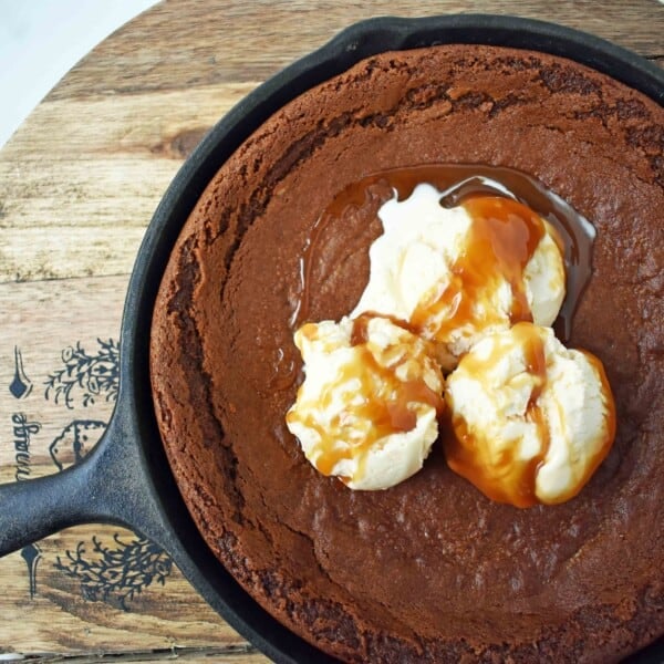 Gingerbread Skillet Cookie with Caramel Sauce by Modern Honey. Perfectly spiced and soft gingerbread cookie topped with vanilla ice cream and caramel sauce.
