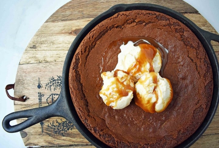 Gingerbread Skillet Cookie with Caramel Sauce by Modern Honey. Perfectly spiced and soft gingerbread cookie topped with vanilla ice cream and caramel sauce.