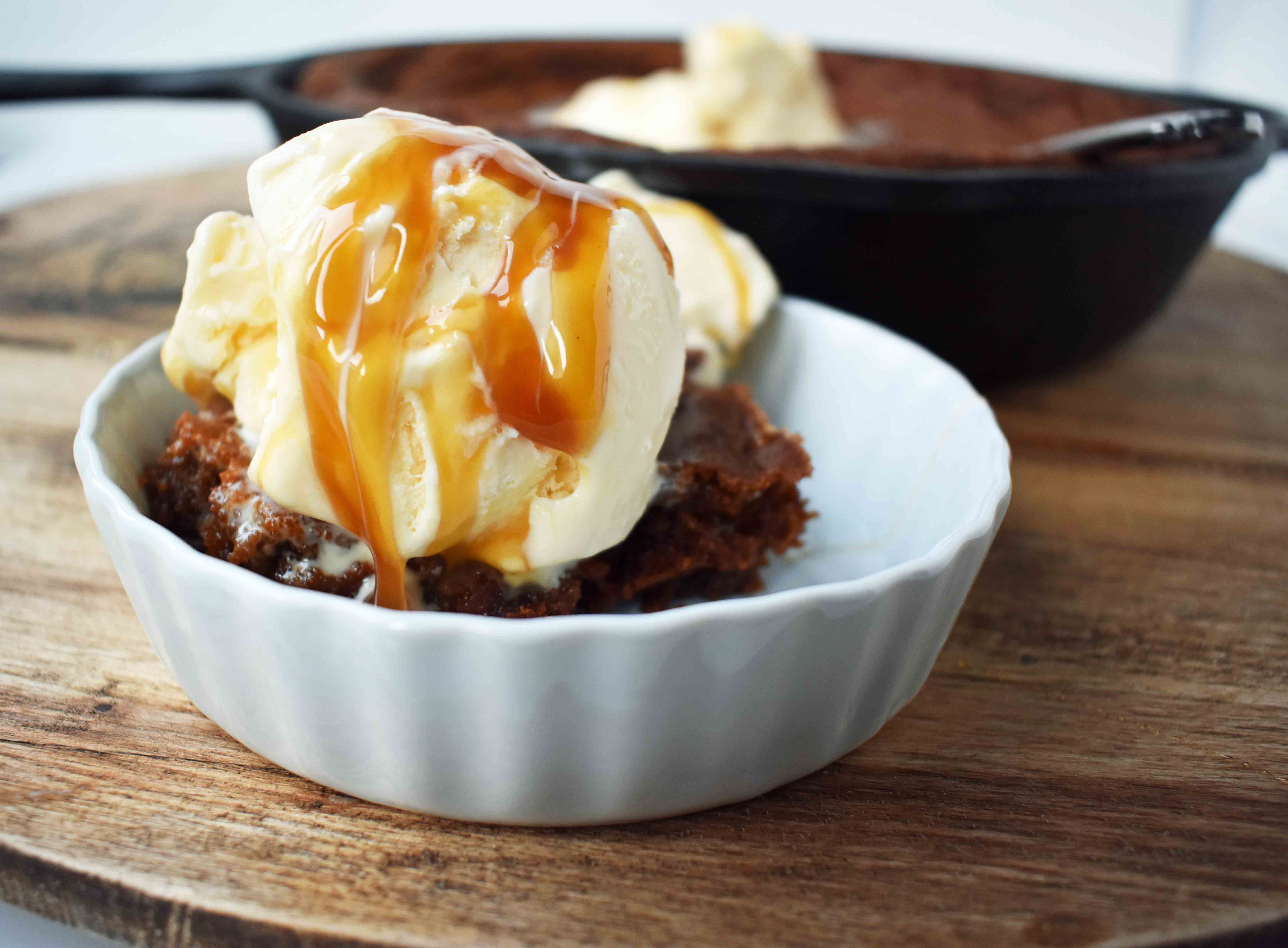 Gingerbread Skillet Cookie with Caramel Sauce by Modern Honey. Perfectly spiced and soft gingerbread cookie topped with vanilla ice cream and caramel sauce.