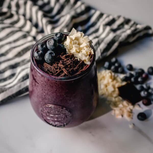 This Berry Chocolate Smoothie is full of blueberries, chocolate protein powder, almond or coconut milk, and almond butter. You can even add in a little banana for extra sweetness. This healthy chocolate blueberry smoothie is full of antioxidants and protein and is the perfect start for your day!
