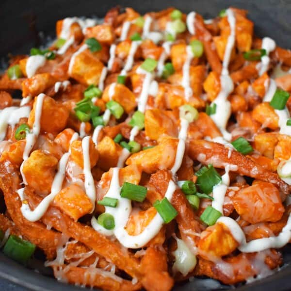 Buffalo Chicken Sweet Potato Fries by Modern Honey. Crisp Sweet Potato Fries topped with Buffalo Wing Chicken, Cheese, Green Onions, and Ranch Dressing.