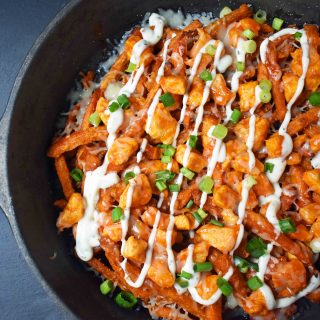 Buffalo Chicken Sweet Potato Fries by Modern Honey. Crisp Sweet Potato Fries topped with Buffalo Wing Chicken, Cheese, Green Onions, and Ranch Dressing.