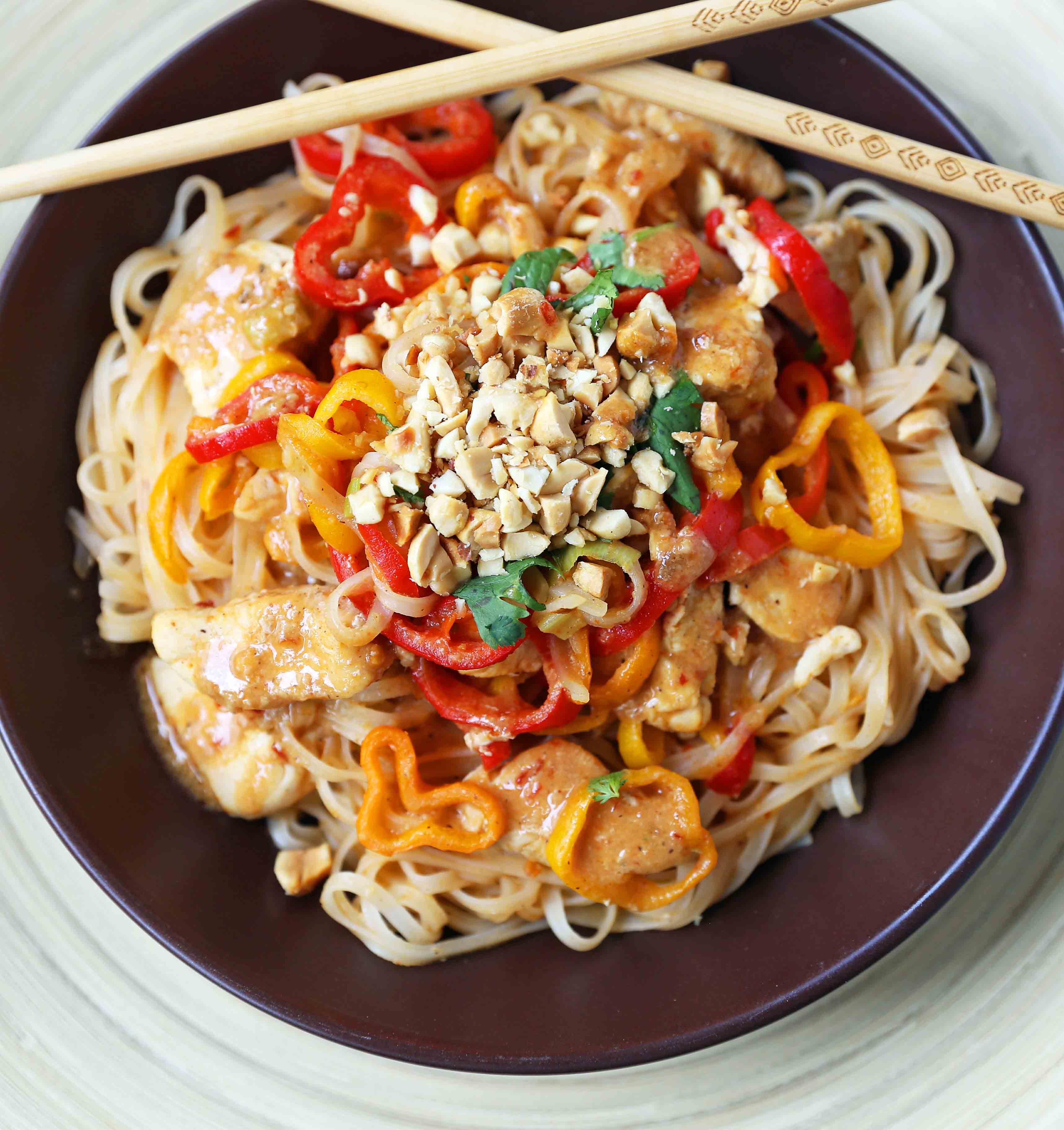 Thai Chicken Noodles. Healthy thai chicken, fresh vegetables, sauteed with a light peanut butter sauce. Better than take-out thai chicken noodles. www.modernhoney.com #thaichickennoodles
