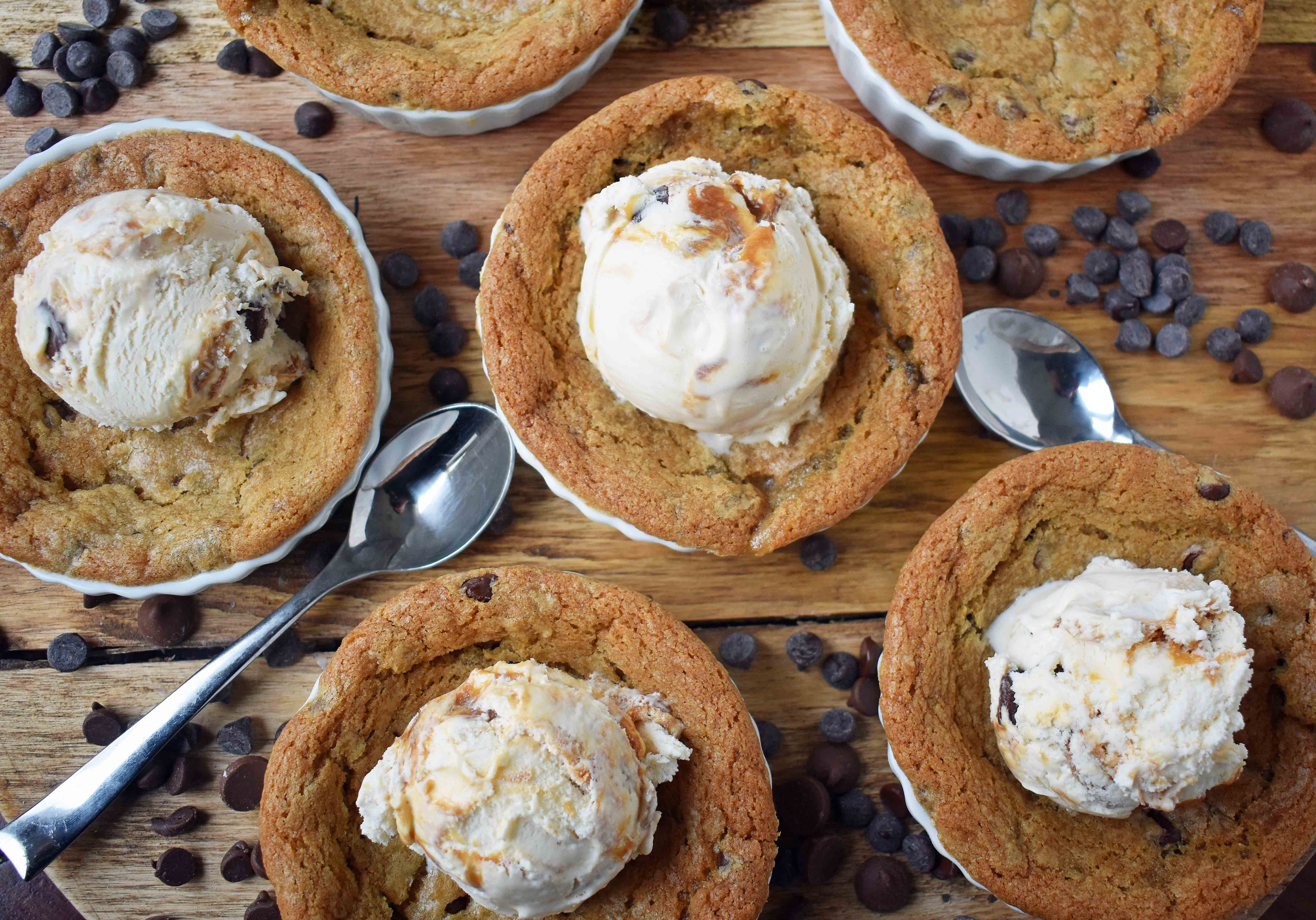 Mini Individual Chocolate Chip Cookie Sundae (Pizookie). The best chocolate chip cookie dough with a few secret techniques. The individual pizookies are baked in a ramekin until the edges are golden brown and the center is warm and gooey. The warm chocolate chip cookie is topped with ice cream. It's the most heavenly dessert! www.modernhoney.com