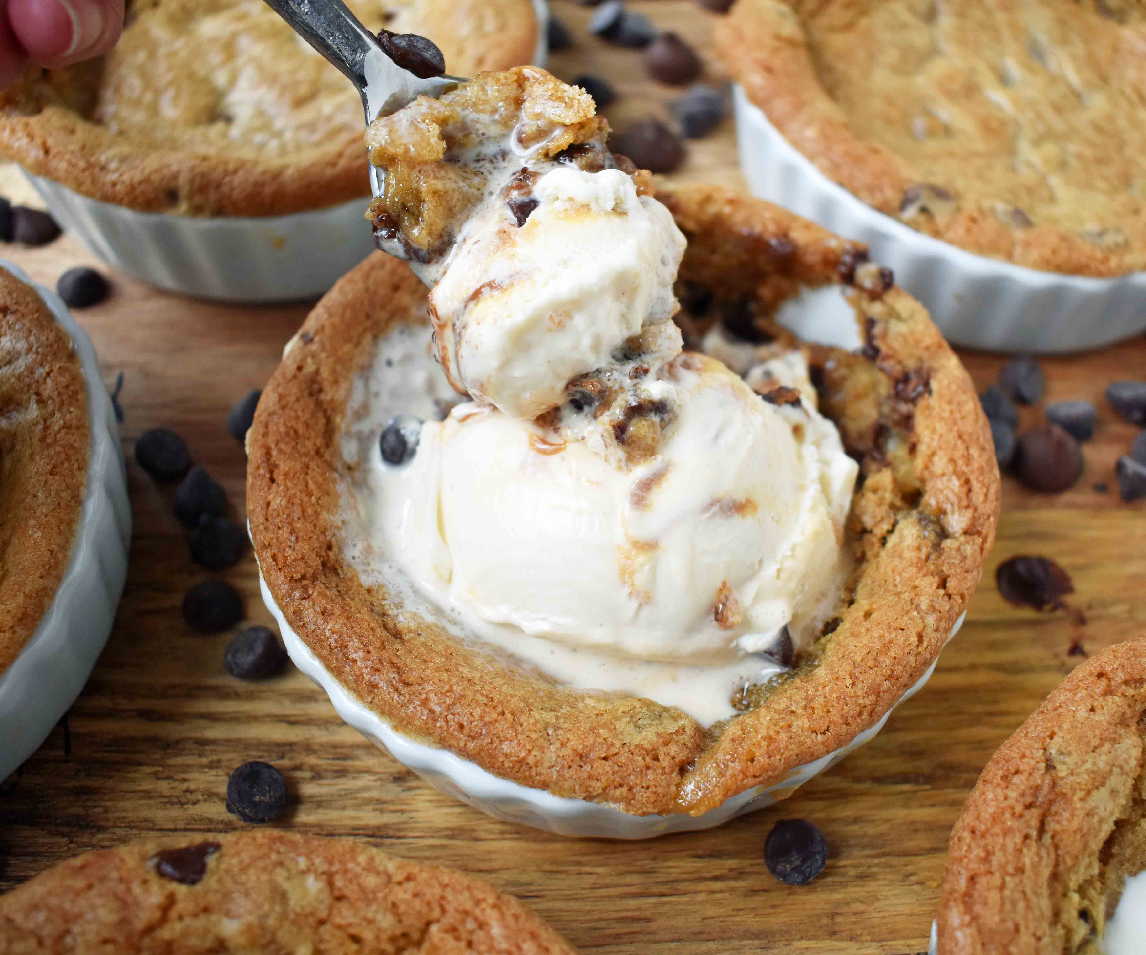 Mini Individual Chocolate Chip Cookie Sundae (Pizookie). The best chocolate chip cookie dough with a few secret techniques. The individual pizookies are baked in a ramekin until the edges are golden brown and the center is warm and gooey. The warm chocolate chip cookie is topped with ice cream. It's the most heavenly dessert! www.modernhoney.com