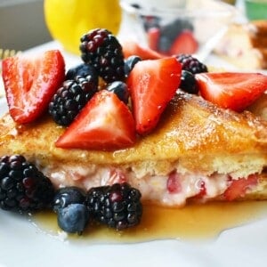 Strawberries and Cream French Toast. Sweet cream cheese, jam and fresh strawberries stuffed between two pieces of soft Texas toast. Dipped into a rich custard batter and cooked until golden brown in skillet. Gourmet french toast made in less than 15 minutes. Perfect topped with fresh berries and homemade whipped cream. www.modernhoney.com