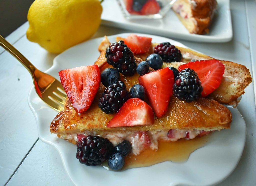 Strawberries and Cream French Toast. Sweet cream cheese, jam and fresh strawberries stuffed between two pieces of soft Texas toast. Dipped into a rich custard batter and cooked until golden brown in skillet. Gourmet french toast made in less than 15 minutes. Perfect topped with fresh berries and homemade whipped cream. www.modernhoney.com