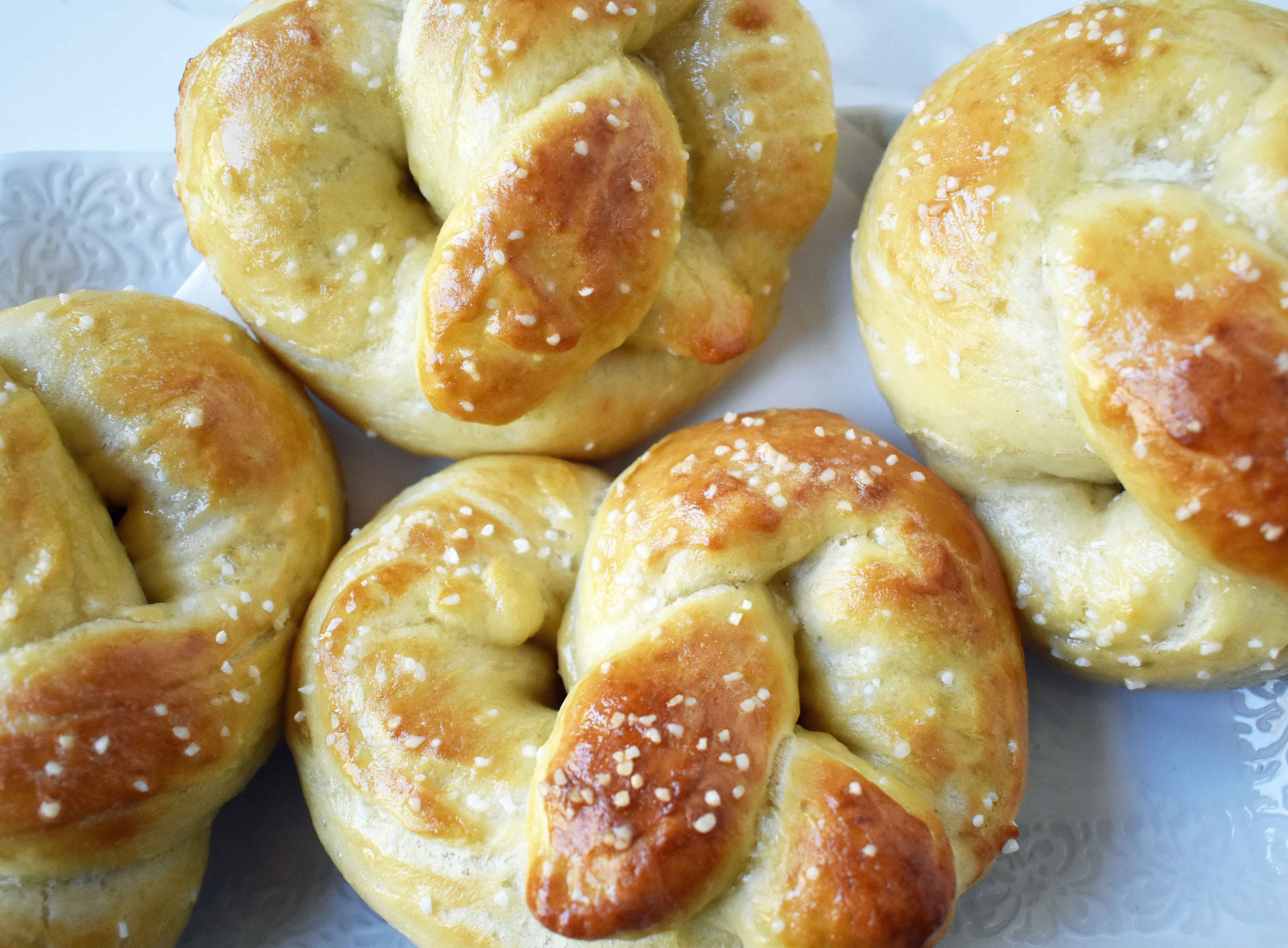 Buttery Soft Pretzels. Homemade, made from scratch soft pretzels. Buttery, soft, and fluffy pretzels with melted butter and coarse salt. Super easy to make! www.modernhoney.com