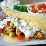 Greek Chicken Gyros with Tzatziki Sauce. Marinated Greek Chicken, grilled to perfection and topped with homemade tzatziki sauce and fresh Greek salad. A healthy and flavorful dish. www.modernhoney.com