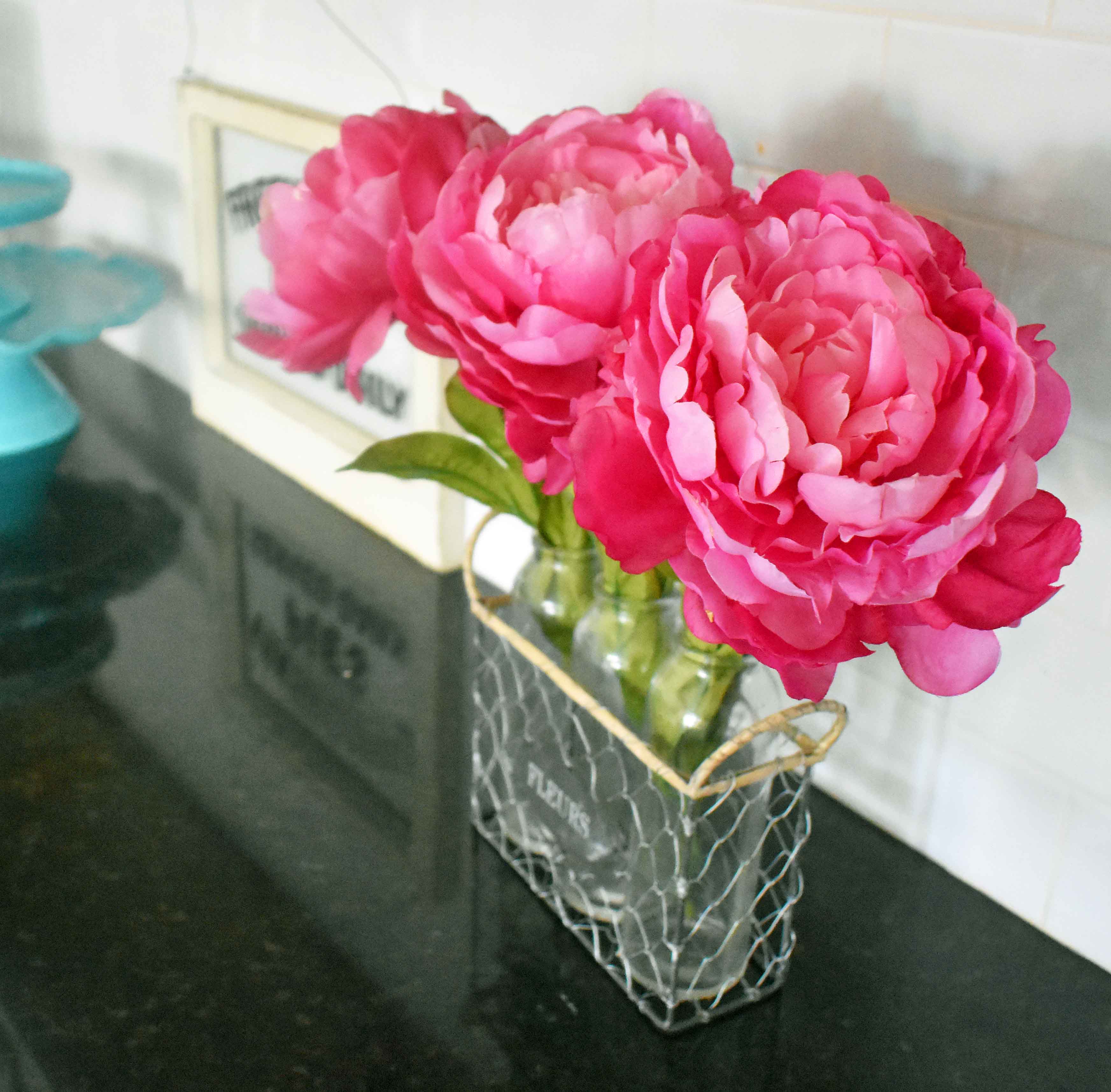 Spring Decoration Ideas. Bright pink peonies in glass flower bud vases. www.modernhoney.com