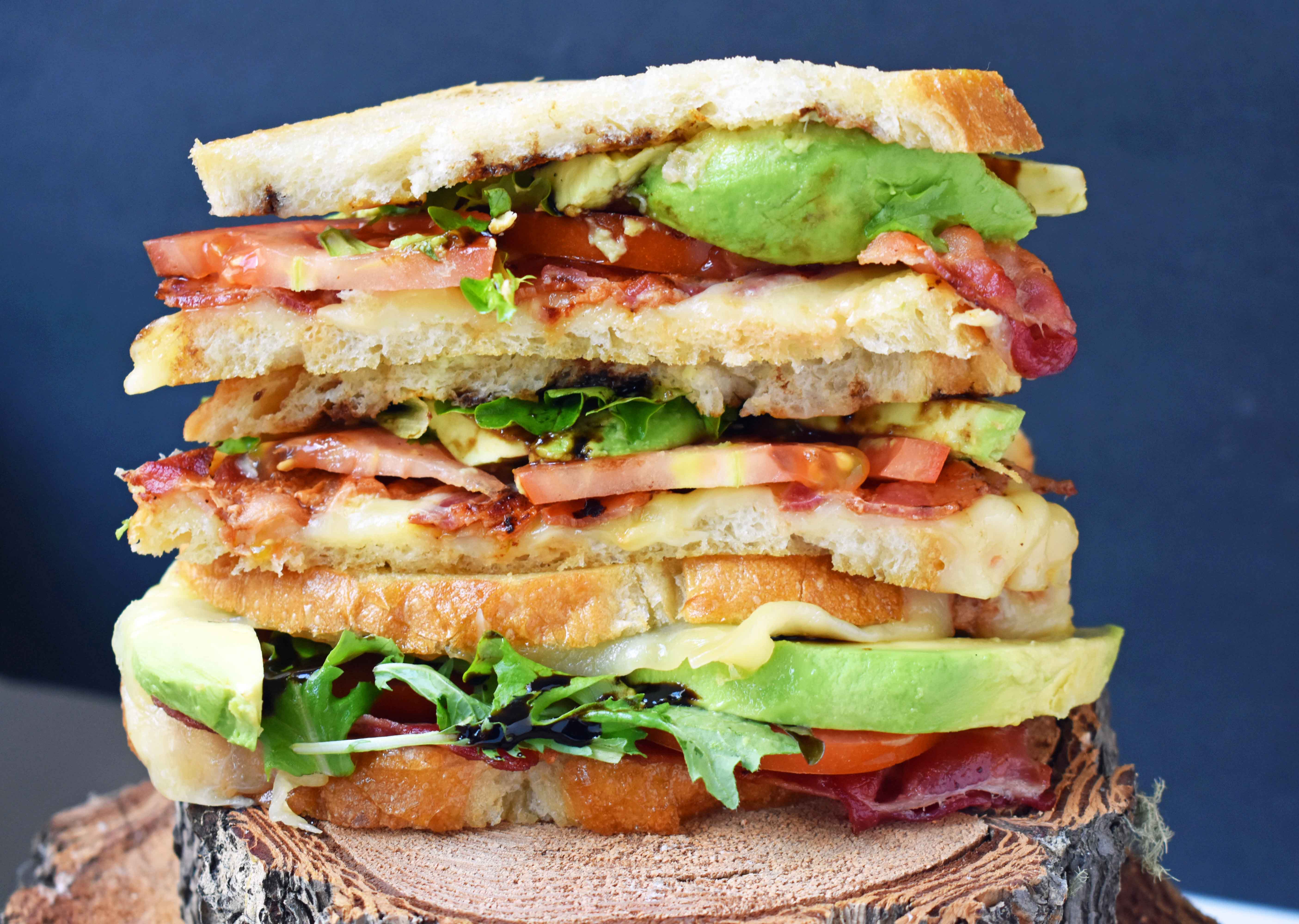 Grown Up Grilled Cheese Sandwich. Three different types of cheese - Swiss, White Sharp Cheddar, and Pepper Jack, crispy bacon, creamy avocado, thinly sliced tomatoes, spring mix, and drizzled with balsamic glaze. A grilled cheese sandwich full of flavor! www.modernhoney.com