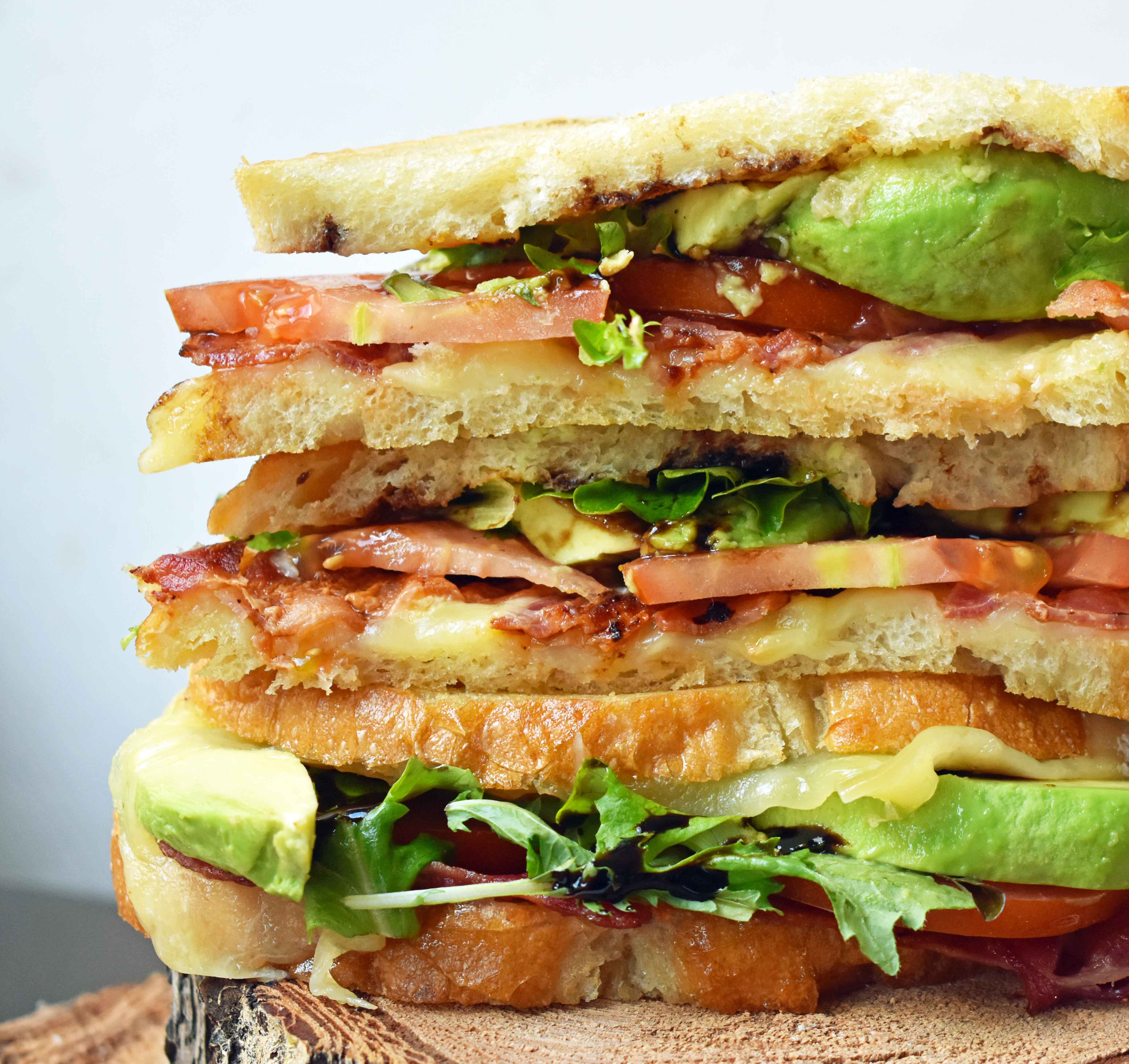 Grown Up Grilled Cheese Sandwich. Three different types of cheese - Swiss, White Sharp Cheddar, and Pepper Jack, crispy bacon, creamy avocado, thinly sliced tomatoes, spring mix, and drizzled with balsamic glaze. A grilled cheese sandwich full of flavor! www.modernhoney.com
