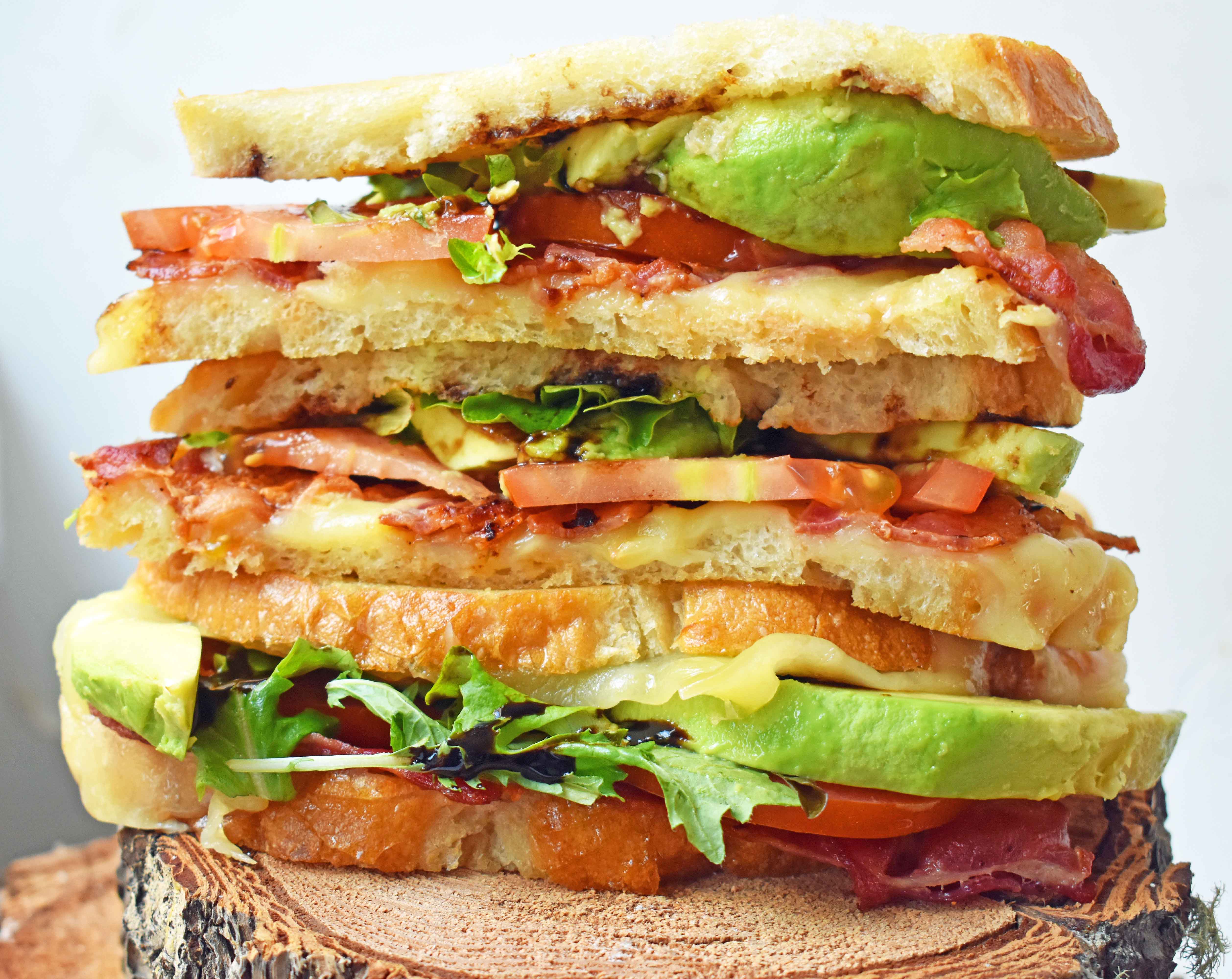 Grown Up Grilled Cheese Sandwich. Three different types of cheese - Swiss, White Sharp Cheddar, and Pepper Jack, crispy bacon, creamy avocado, thinly sliced tomatoes, spring mix, and drizzled with balsamic glaze. A grilled cheese sandwich full of flavor! www.modernhoney.com
