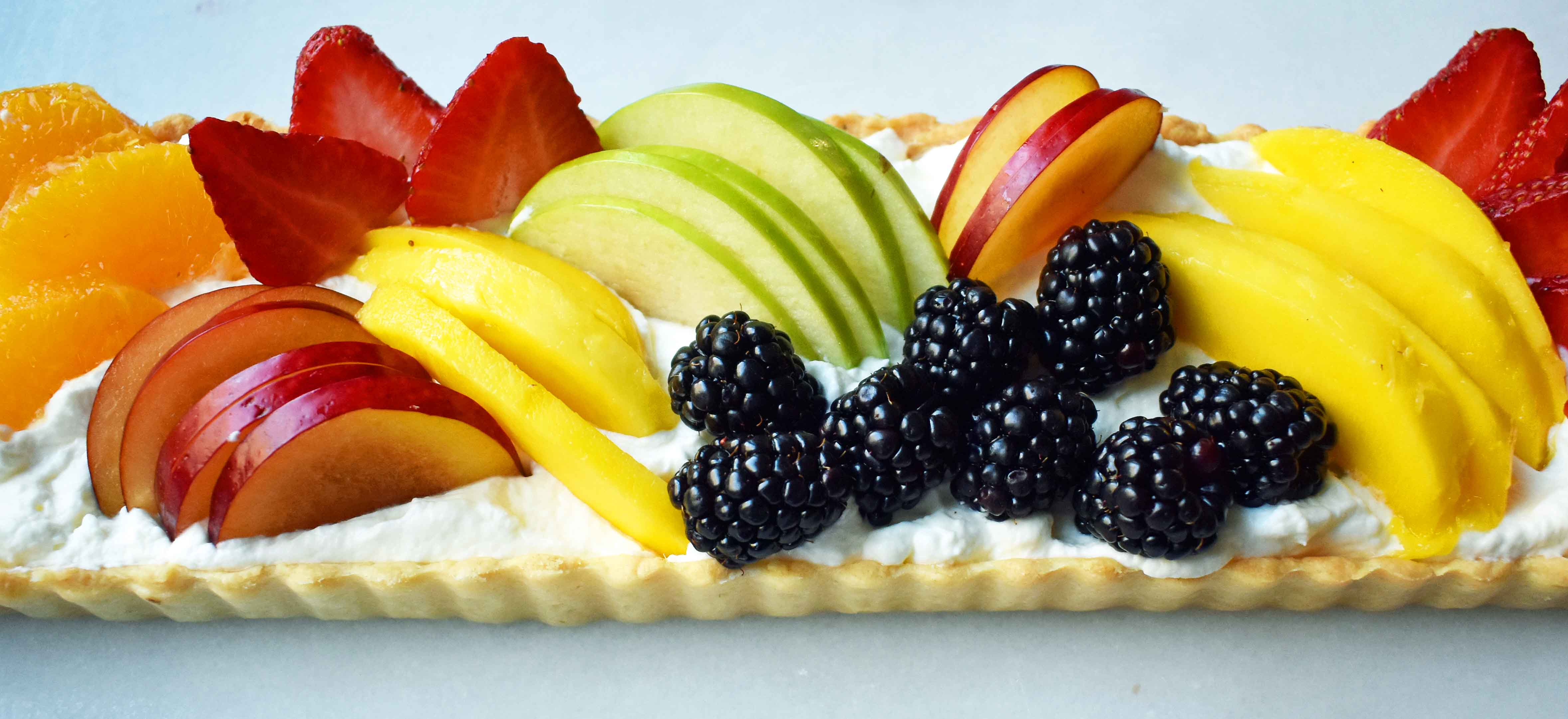 Fresh Fruit Tart with Vanilla Pastry Cream. Buttery, flaky tart filled with homemade vanilla bean custard and topped with fresh fruits. A classic French dessert that is a huge crowd pleaser. www.modernhoney.com