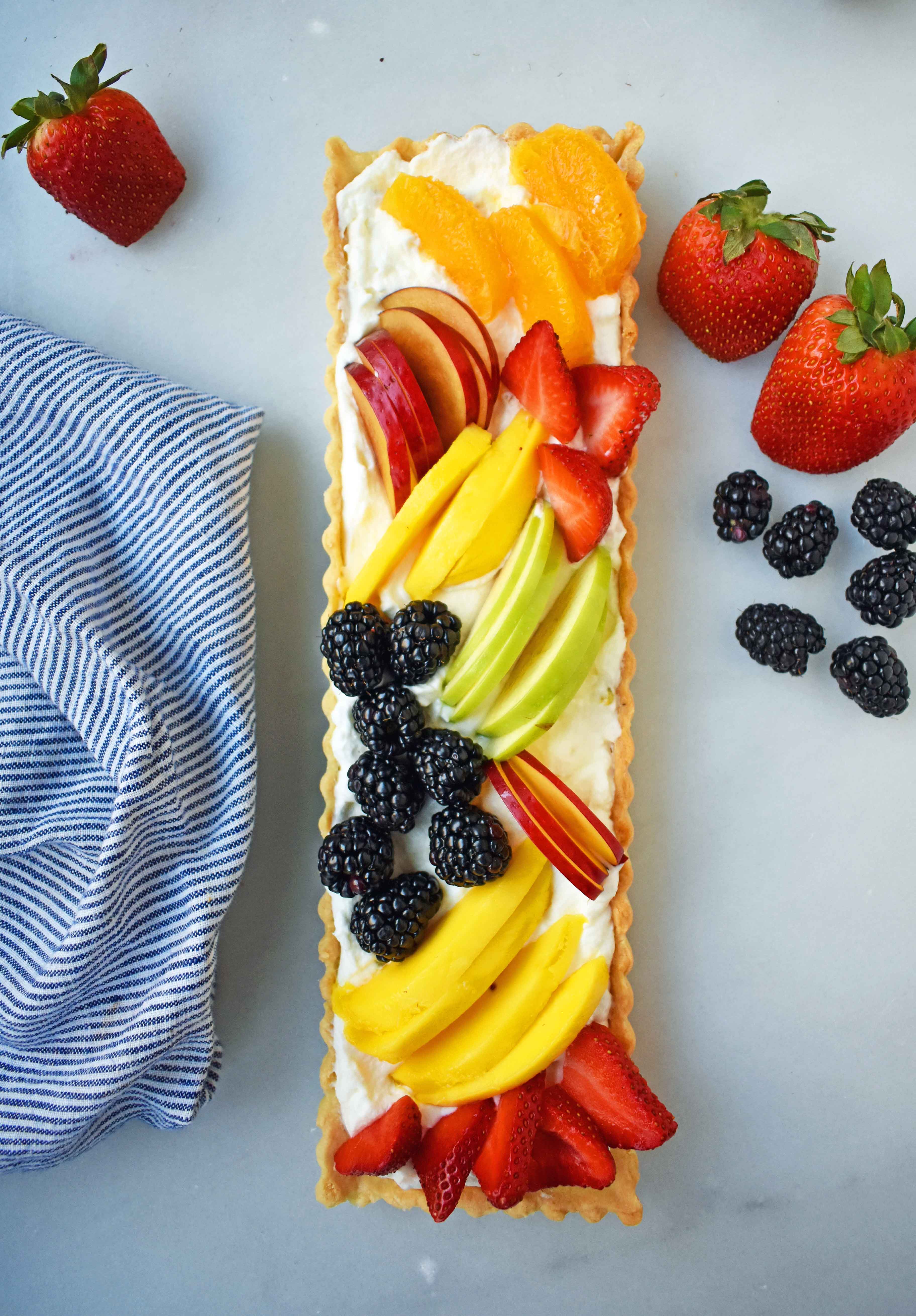 Fresh Fruit Tart with Vanilla Pastry Cream. Buttery, flaky tart filled with homemade vanilla bean custard and topped with fresh fruits. A classic French dessert that is a huge crowd pleaser. www.modernhoney.com