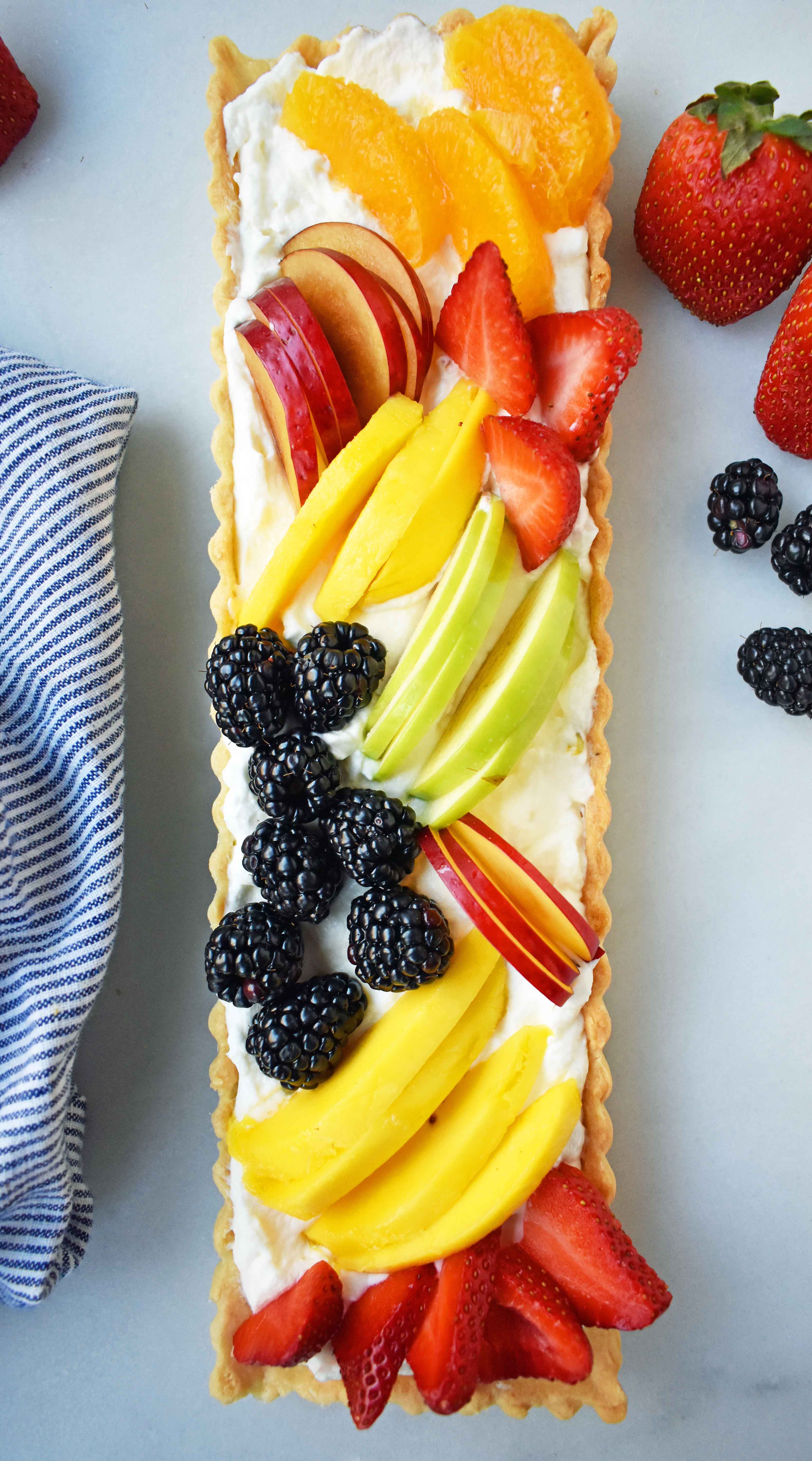 Fresh Fruit Tart with Vanilla Pastry Cream. Buttery, flaky tart filled with homemade vanilla bean custard and topped with fresh fruits. A classic French dessert that is a huge crowd pleaser. www.modernhoney.com