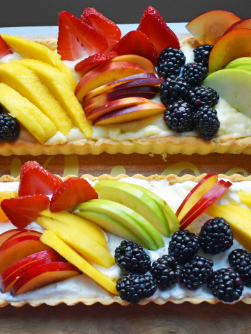 Lemon Cream Filled Fruit Tart. Buttery, flaky pie crust baked in tart pan and filled with homemade lemon cream and topped with sliced fresh fruit. A beautiful Spring and Summer dessert that everyone loves. www.modernhoney.com
