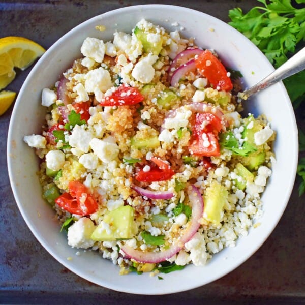 Mediterranean Quinoa Salad with feta cheese, tomatoes, cucumber, and red onions, all tossed in a red wine vinaigrette. www.modernhoney.com