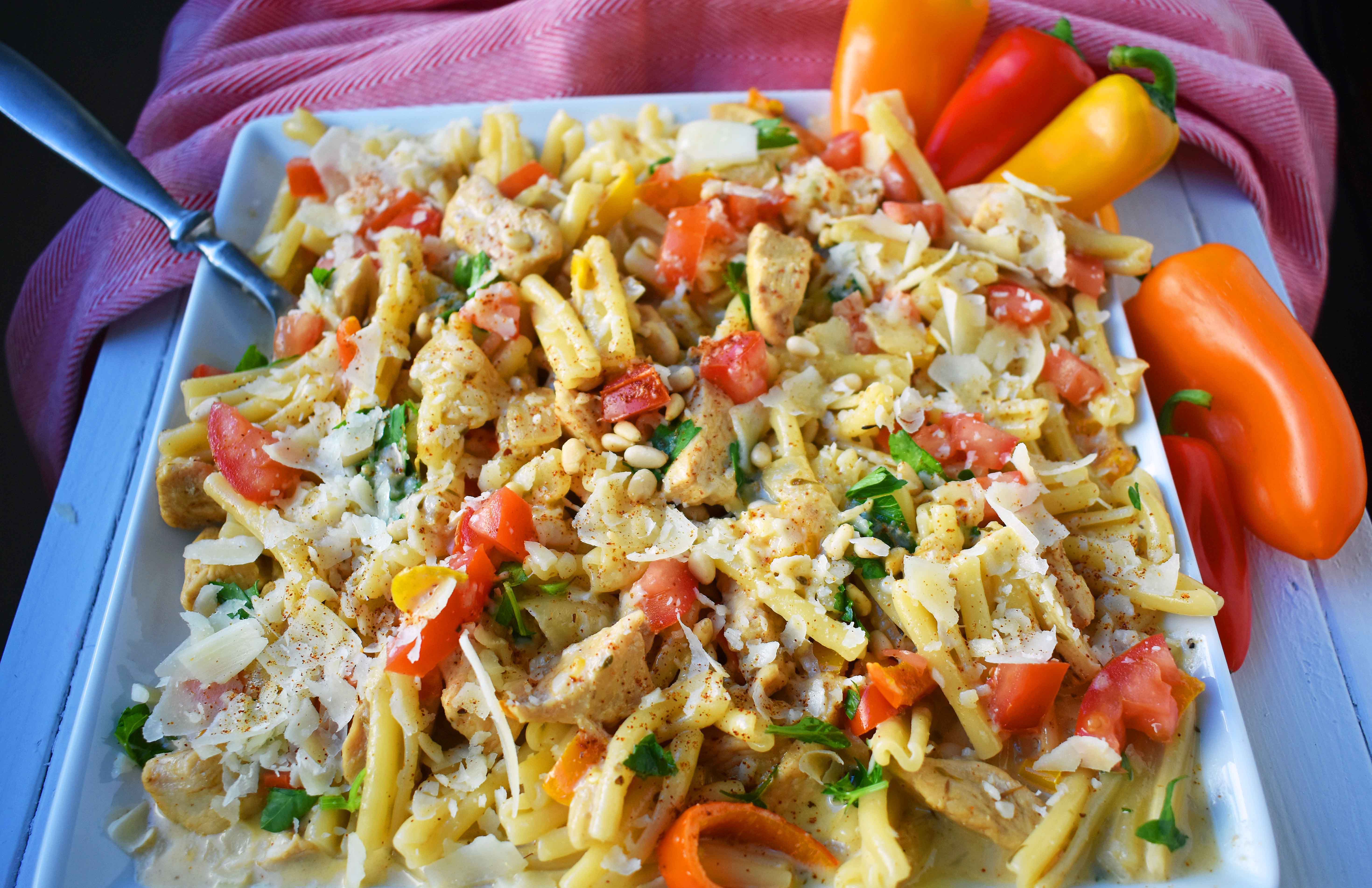 Cajun Louisiana Chicken Pasta made with onions, peppers, chicken, and cajun cream tossed with your favorite kind of pasta and topped with parmesan cheese and pine nuts. A super flavorful creamy pasta dish. www.modernhoney.com