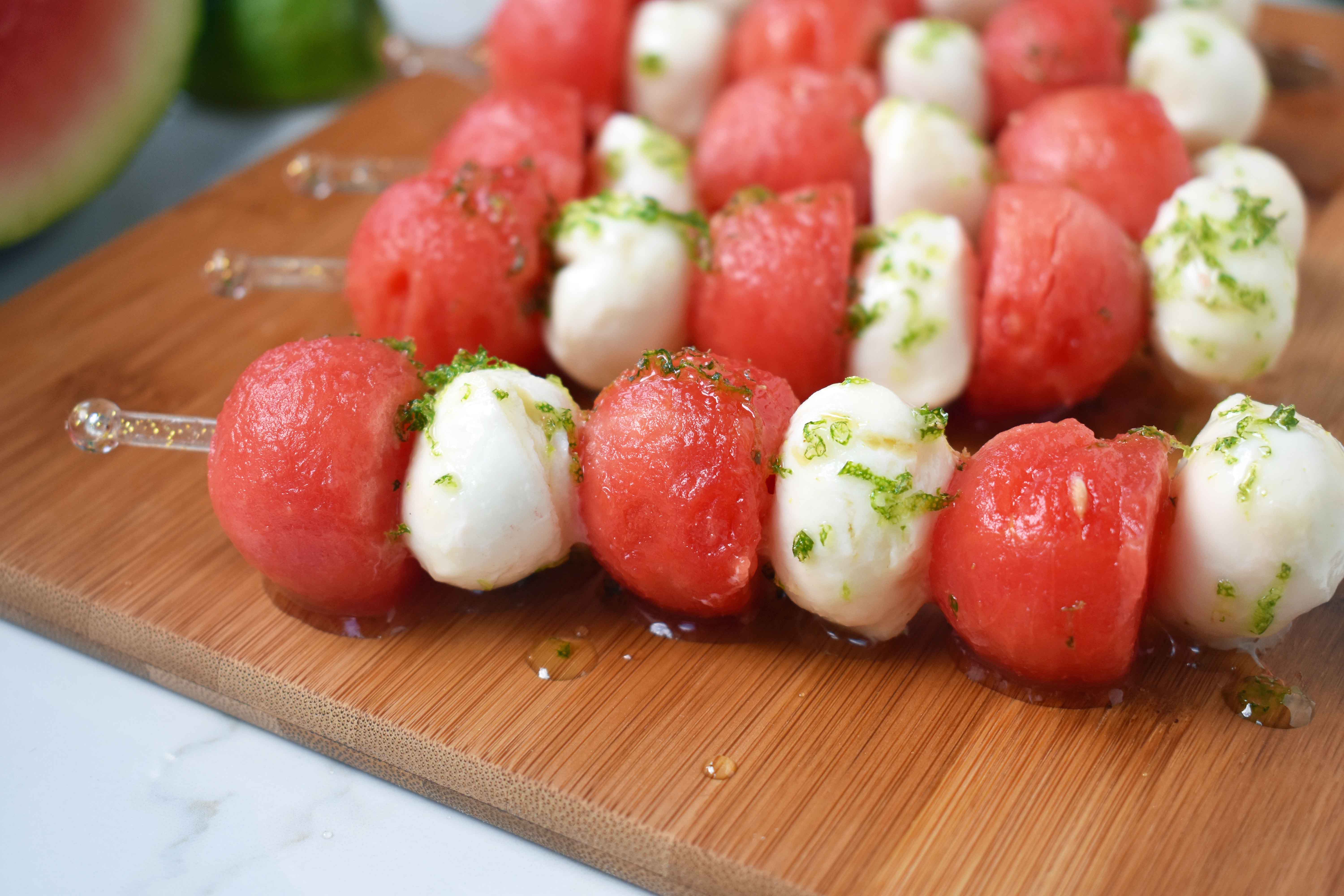 Fresh Mozzarella Watermelon Skewers with Honey Lime Drizzle. Round watermelon and fresh mozzarella balls and layered to make a kabob and drizzled with homemade honey lime sauce. A perfect appetizer or side dish for any BBQ or party. www.modernhoney.com