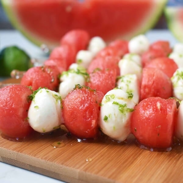 Fresh Mozzarella Watermelon Skewers with Honey Lime Drizzle. Round watermelon and fresh mozzarella balls and layered to make a kabob and drizzled with homemade honey lime sauce. A perfect appetizer or side dish for any BBQ or party. www.modernhoney.com