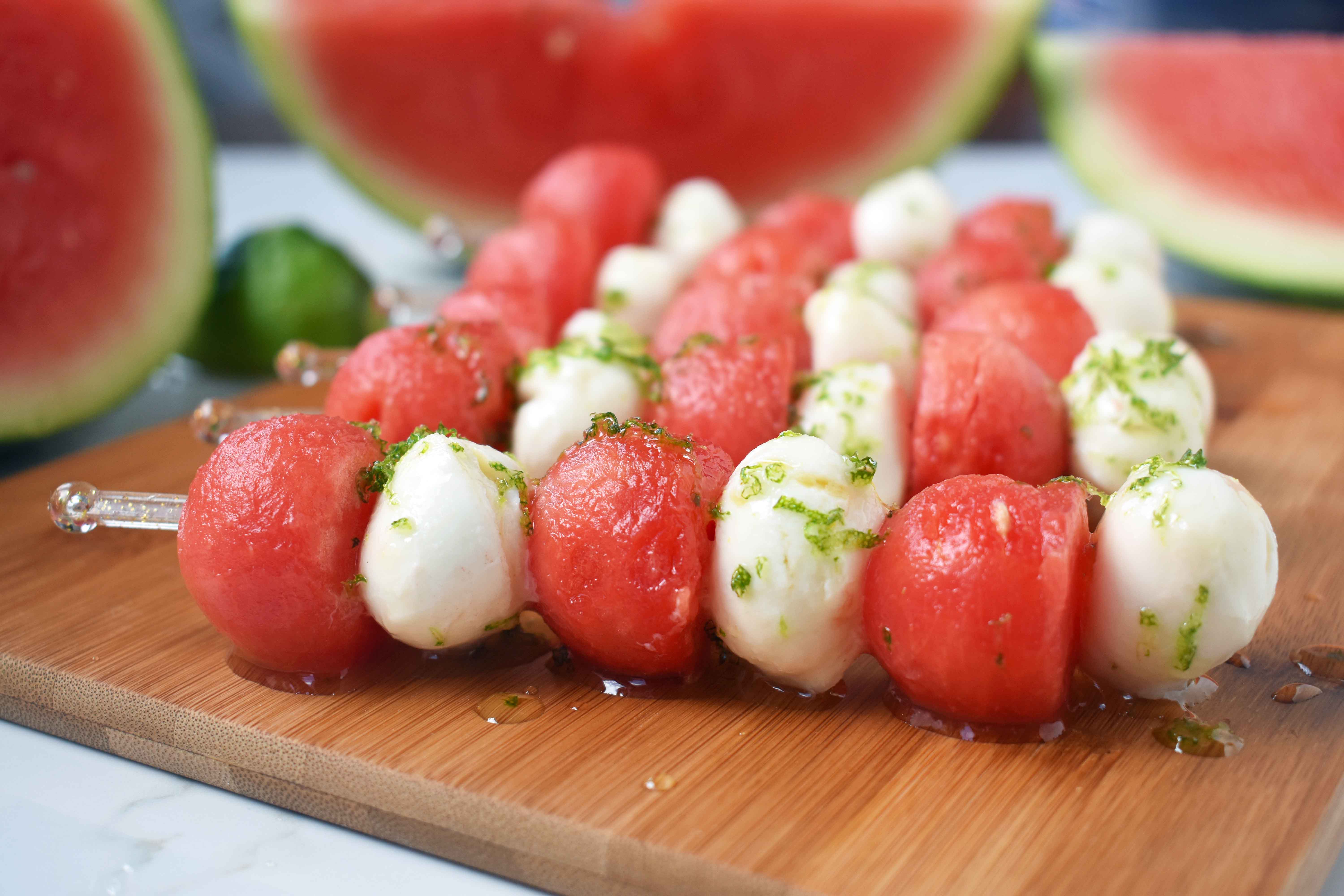 Fresh Mozzarella Watermelon Skewers with Honey Lime Drizzle. Round watermelon and fresh mozzarella balls and layered to make a kabob and drizzled with homemade honey lime sauce. A perfect appetizer or side dish for any BBQ or party. www.modernhoney.com