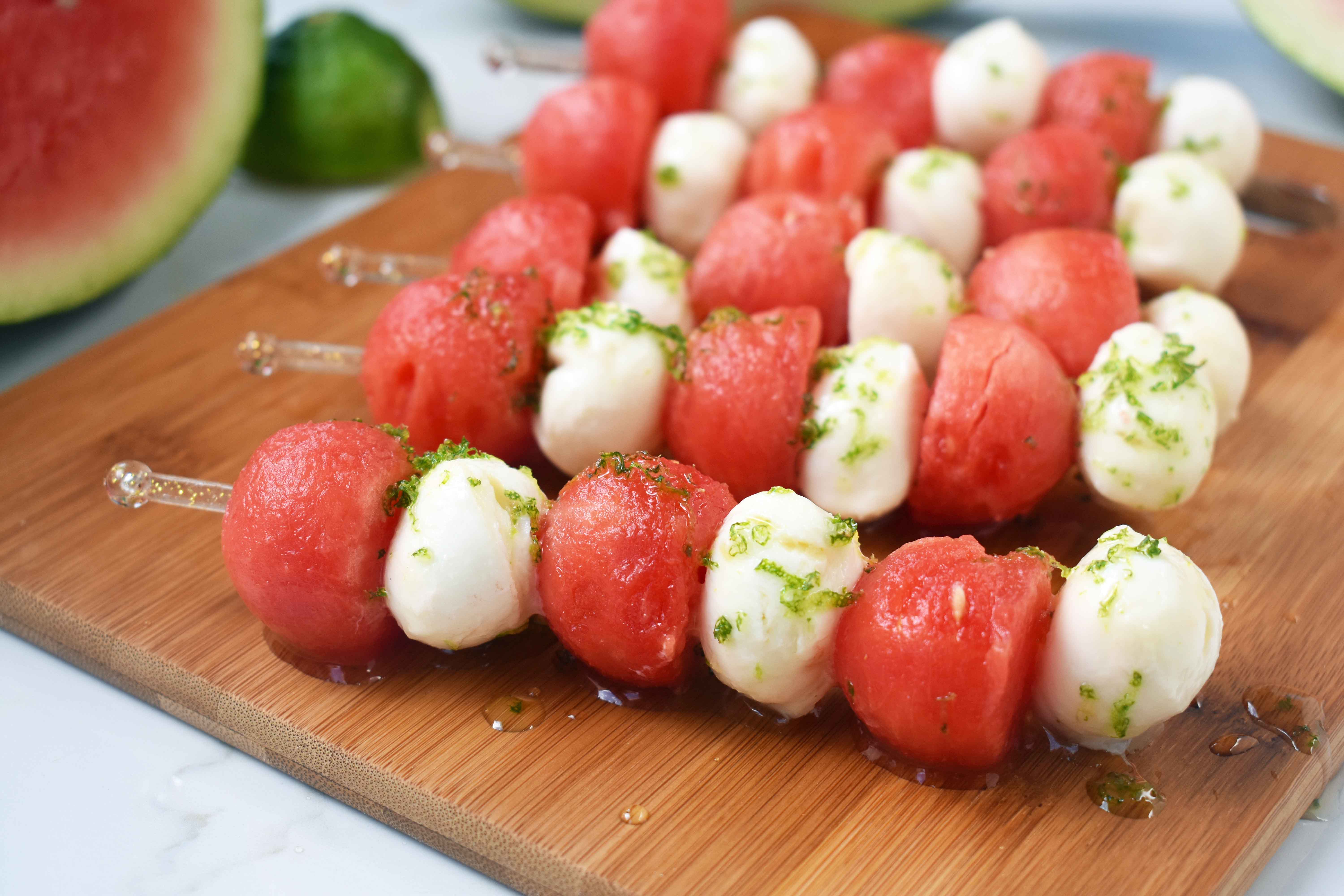 Fresh Mozzarella Watermelon Skewers with Honey Lime Drizzle. Round watermelon and fresh mozzarella balls and layered to make a kabob and drizzled with homemade honey lime sauce. A perfect appetizer or side dish for any BBQ or party. www.modernhoney.com