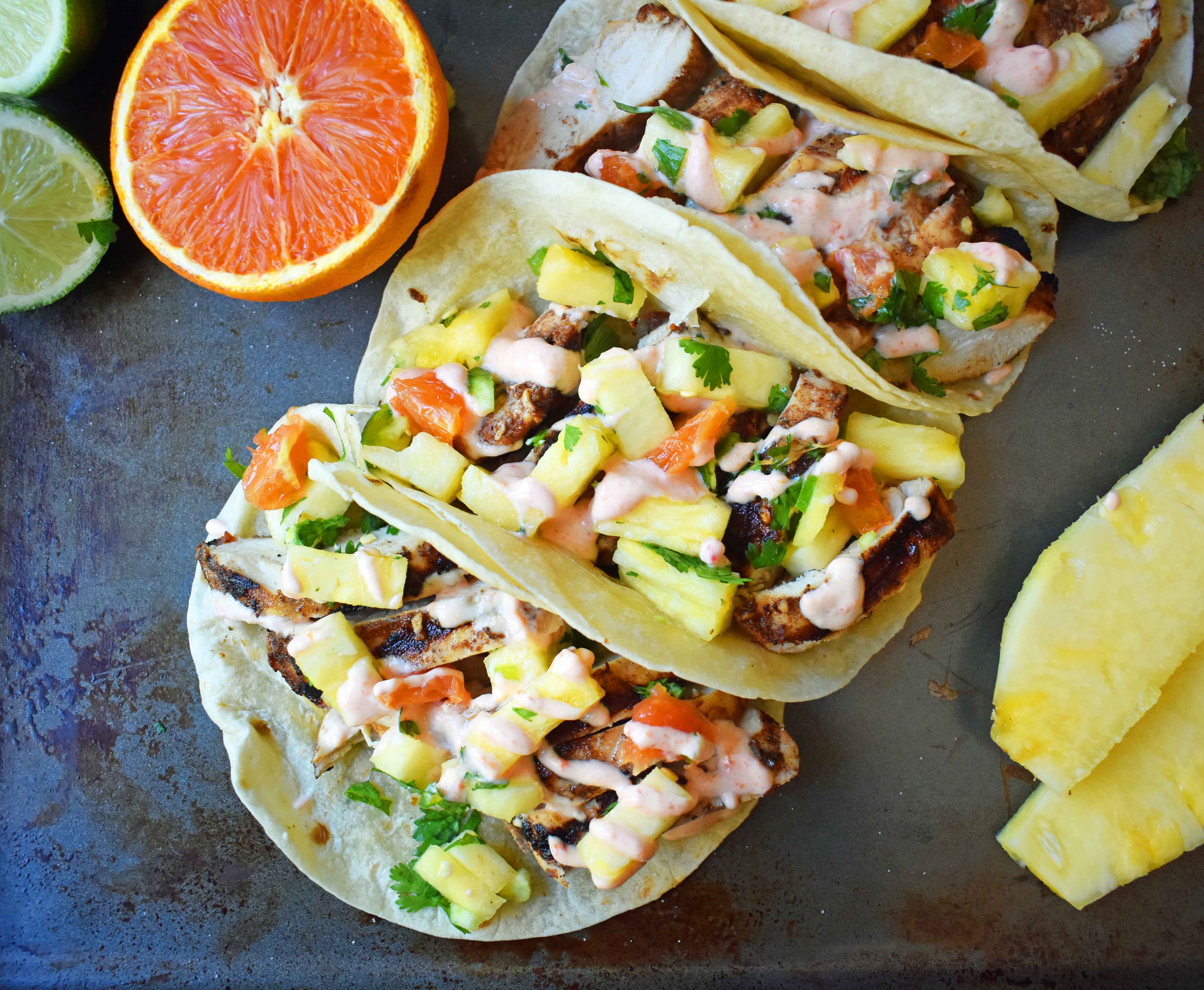 Jamaican Jerk Chicken Tacos. Caribbean spiced citrus grilled chicken filled tacos with pineapple salsa and spicy cream. www.modernhoney.com
