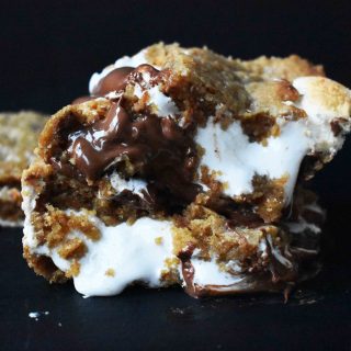S'mores Bars made with homemade graham cracker cookie dough, marshmallow fluff, and milk chocolate bars. The popular s'more made into a cookie bar. www.modernhoney.com