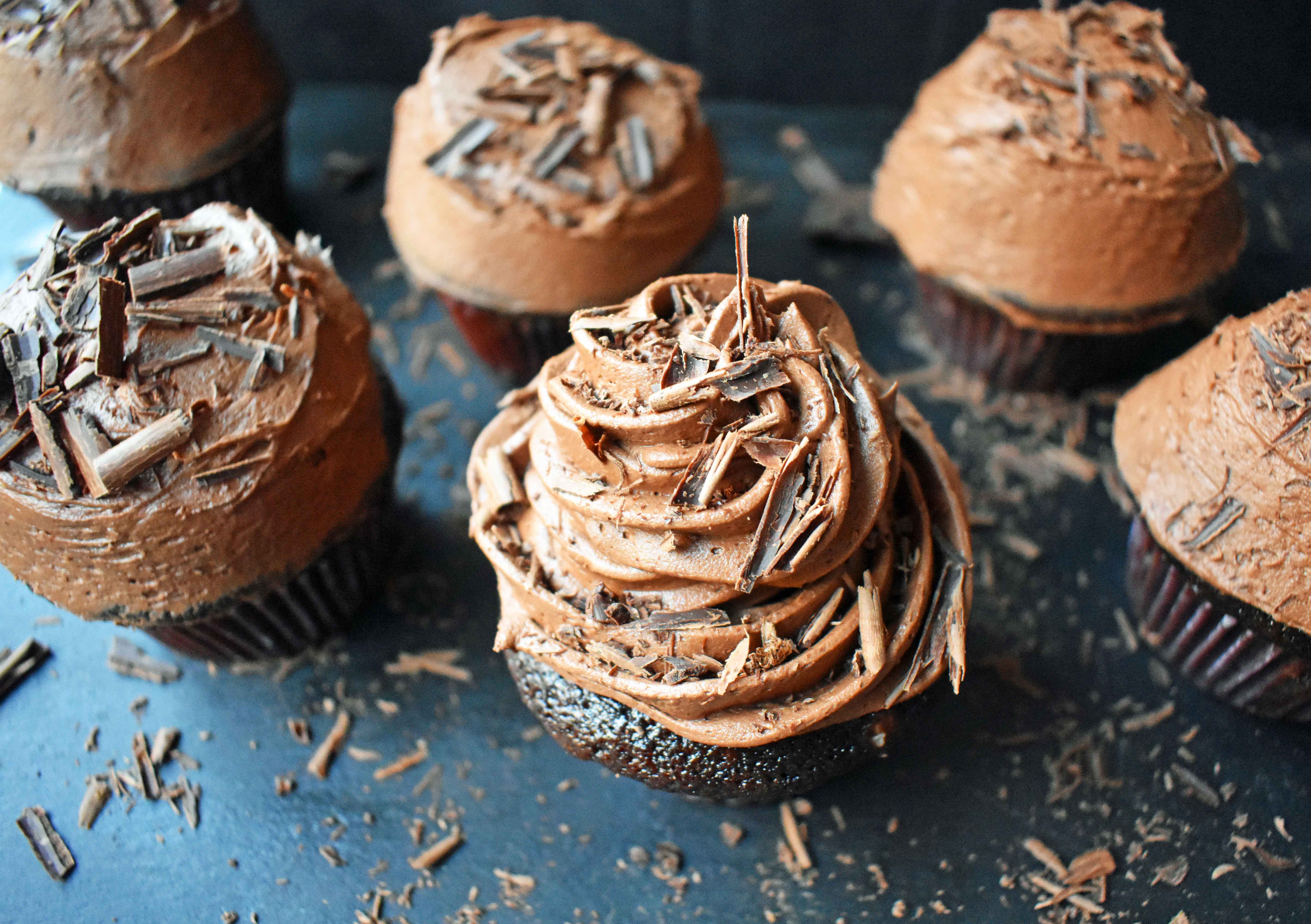 Chocolate Bombshell Birthday Cupcakes. Rich, tender, and fluffy chocolate cake topped with homemade perfect chocolate buttercream frosting. A match made in heaven! These are the ultimate chocolate cupcake. www.modernhoney.com