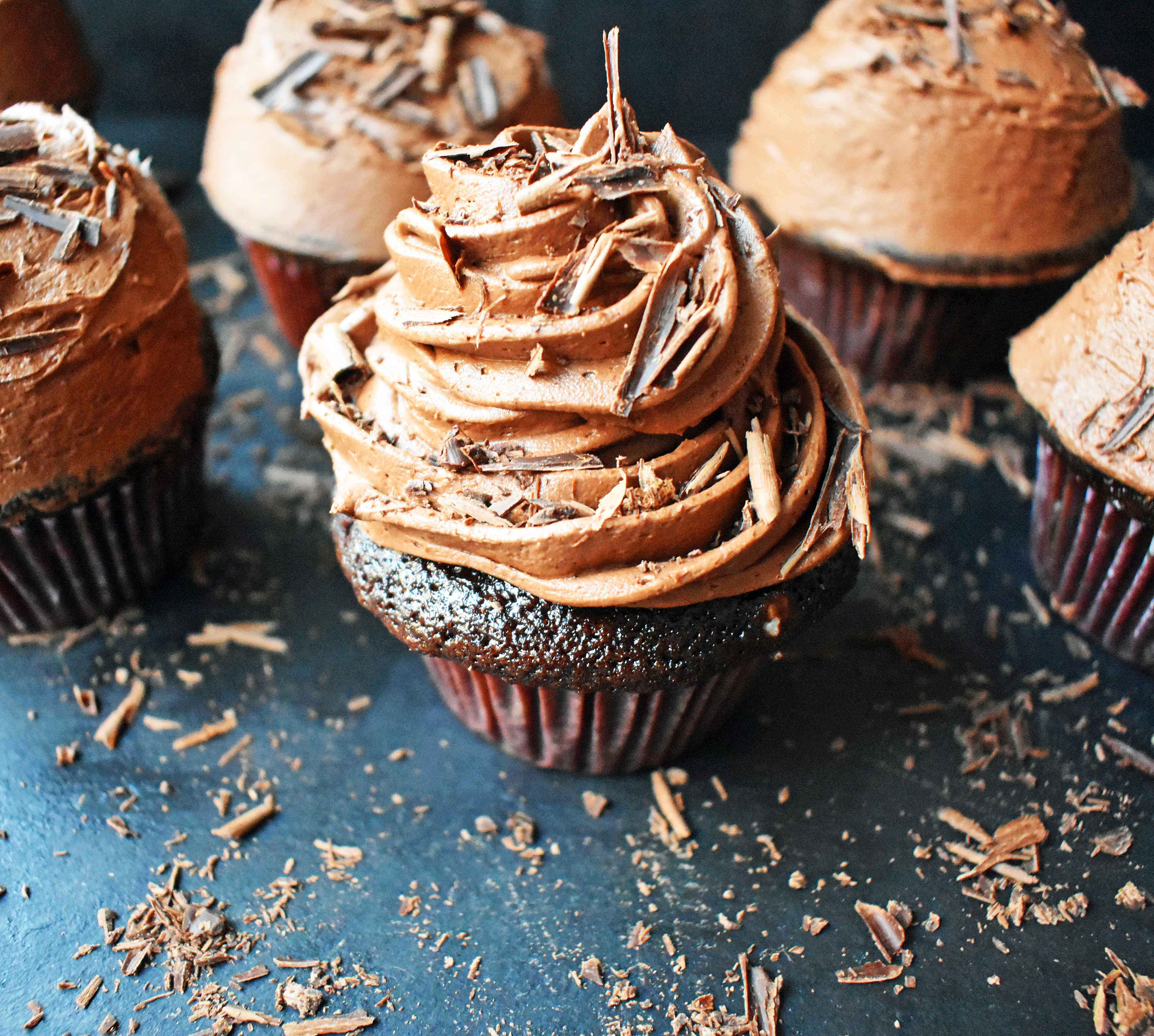 Chocolate Bombshell Birthday Cupcakes. Rich, tender, and fluffy chocolate cake topped with homemade perfect chocolate buttercream frosting. A match made in heaven! These are the ultimate chocolate cupcake. www.modernhoney.com