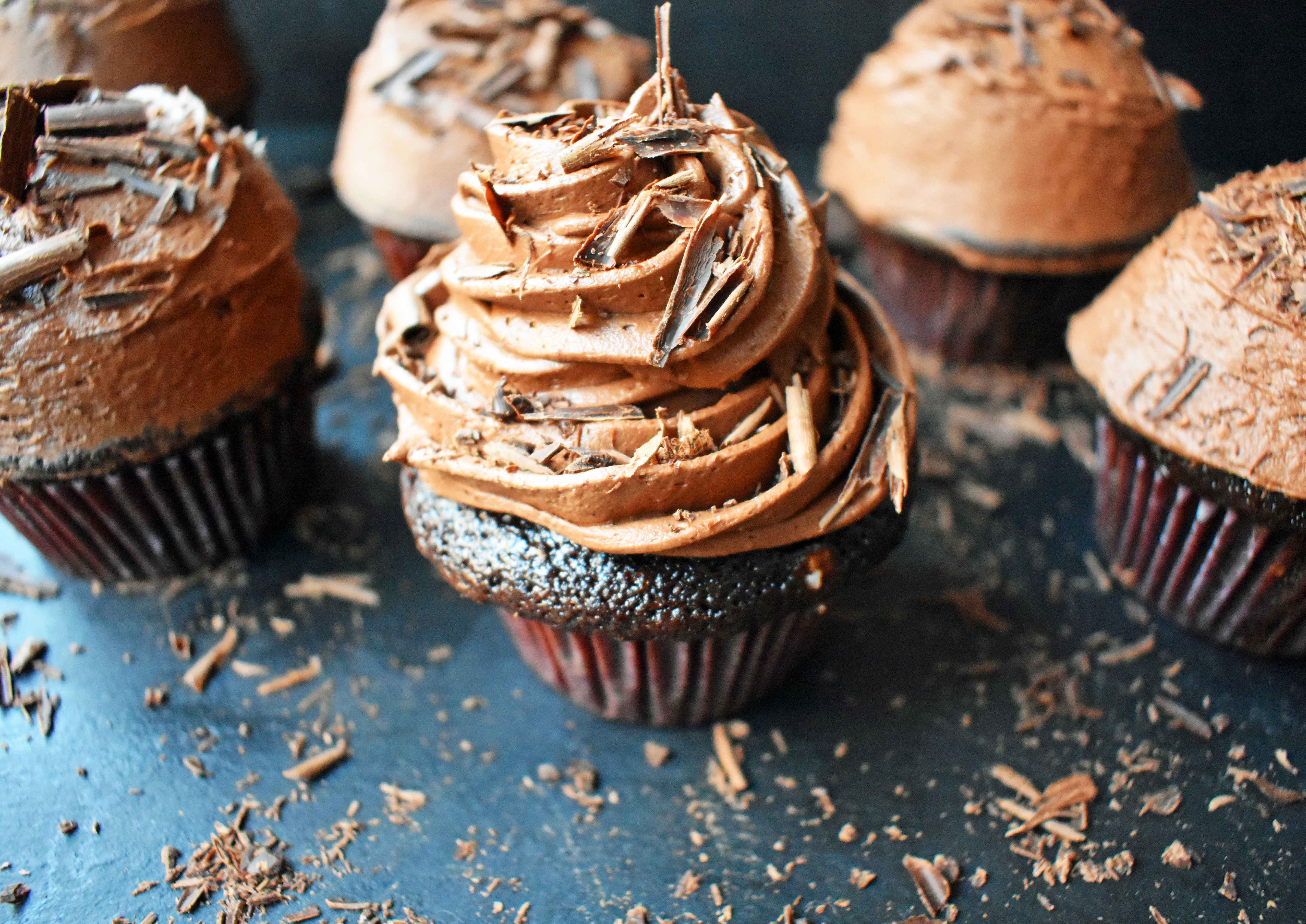 Chocolate Bombshell Birthday Cupcakes. Rich, tender, and fluffy chocolate cake topped with homemade perfect chocolate buttercream frosting. A match made in heaven! These are the ultimate chocolate cupcake. www.modernhoney.com