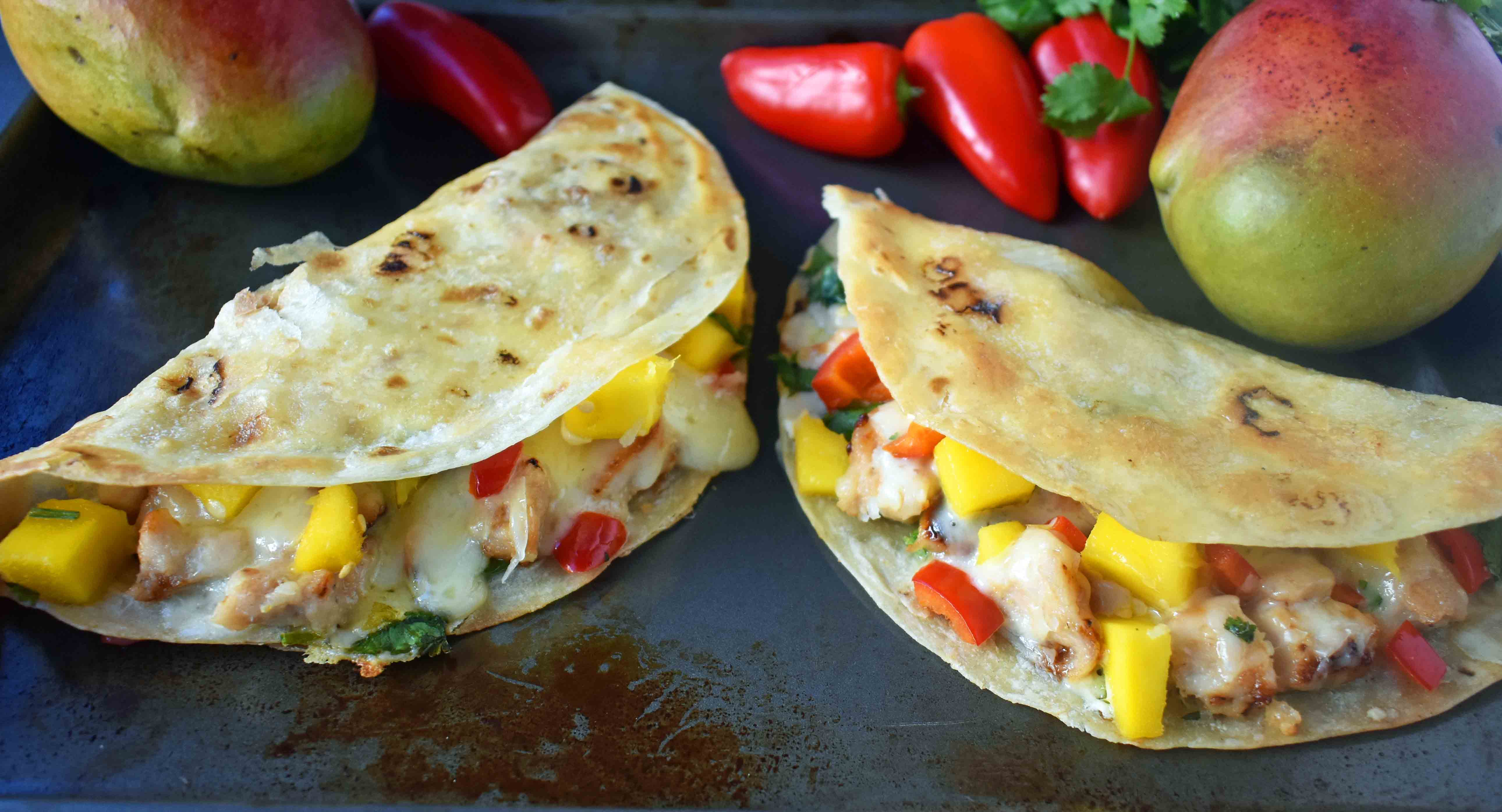 Chicken Mango Quesadillas made with honey lime chicken, homemade fresh mango salsa, pepper jack cheese, and an optional jalapeno cream cheese all melted inside a buttery tortilla. A popular Mexican dinner made in less than 30 minutes. www.modernhoney.com