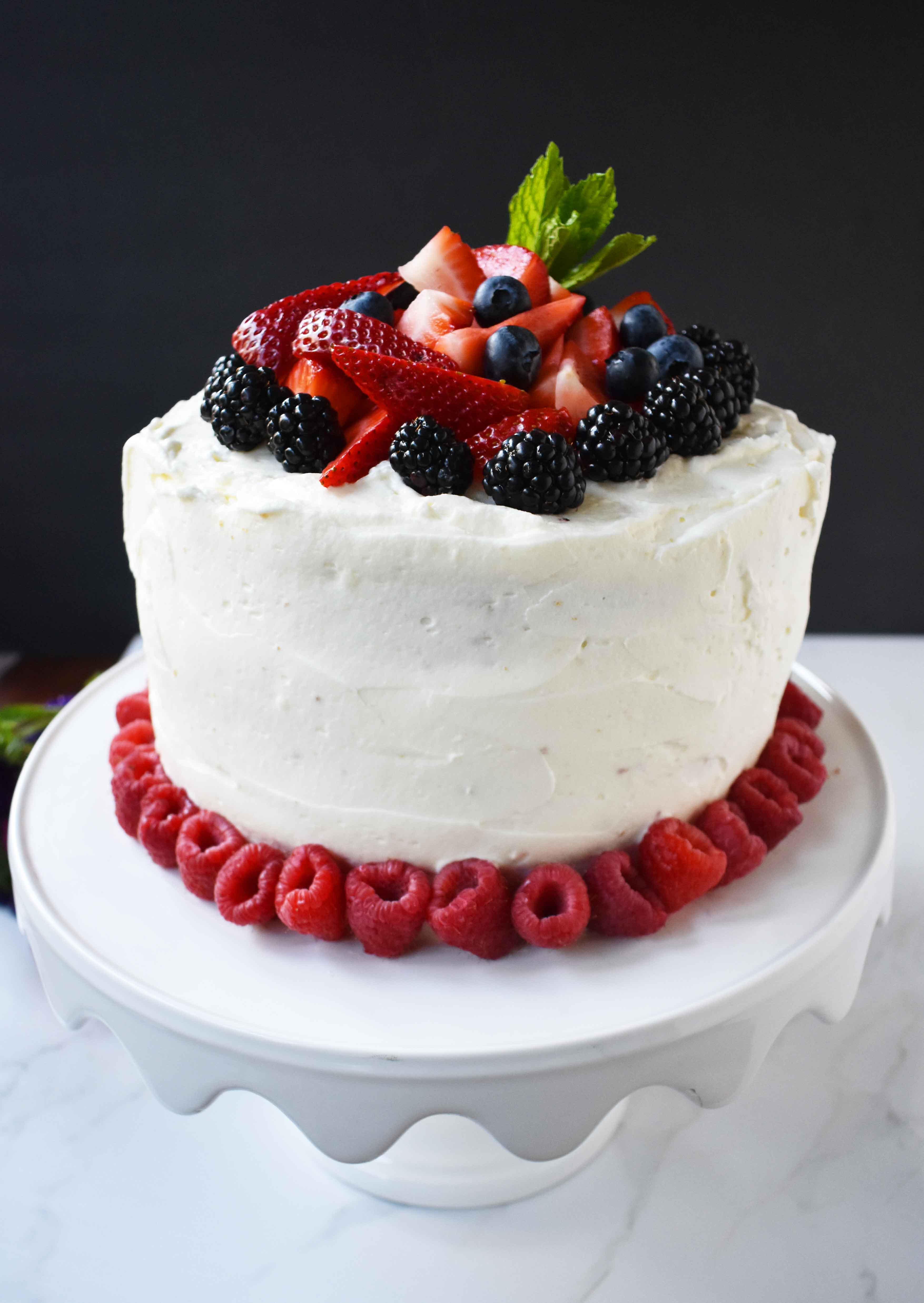 Berry Chantilly Cream Cake. Layers of perfect yellow cake, chantilly cream, jam, and fresh strawberries, raspberries, blackberries, and blueberries. The perfect Spring and Summer dessert that everyone will love. www.modernhoney.com