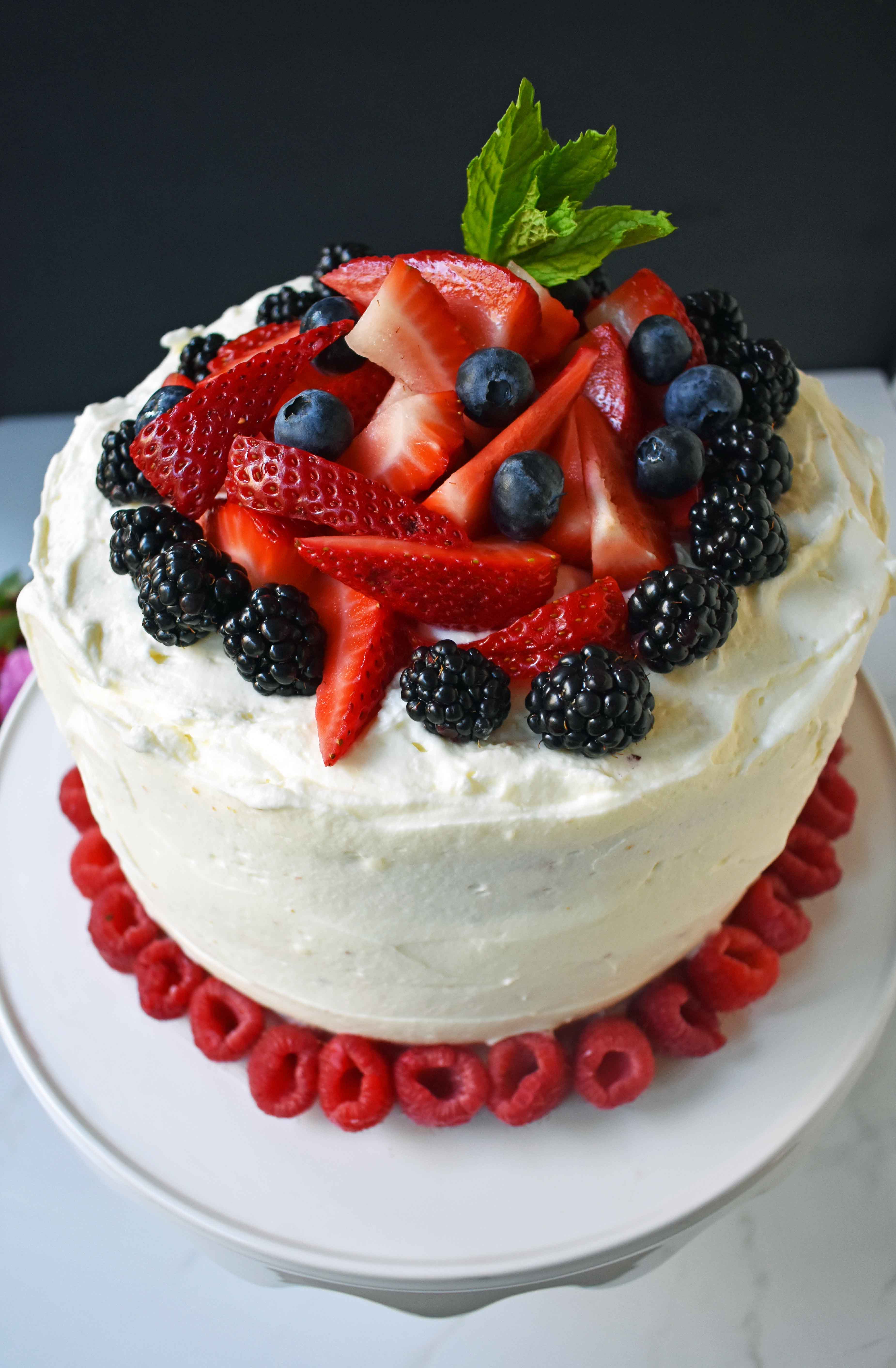 Berry Chantilly Cream Cake. Layers of perfect yellow cake, chantilly cream, jam, and fresh strawberries, raspberries, blackberries, and blueberries. The perfect Spring and Summer dessert that everyone will love. www.modernhoney.com