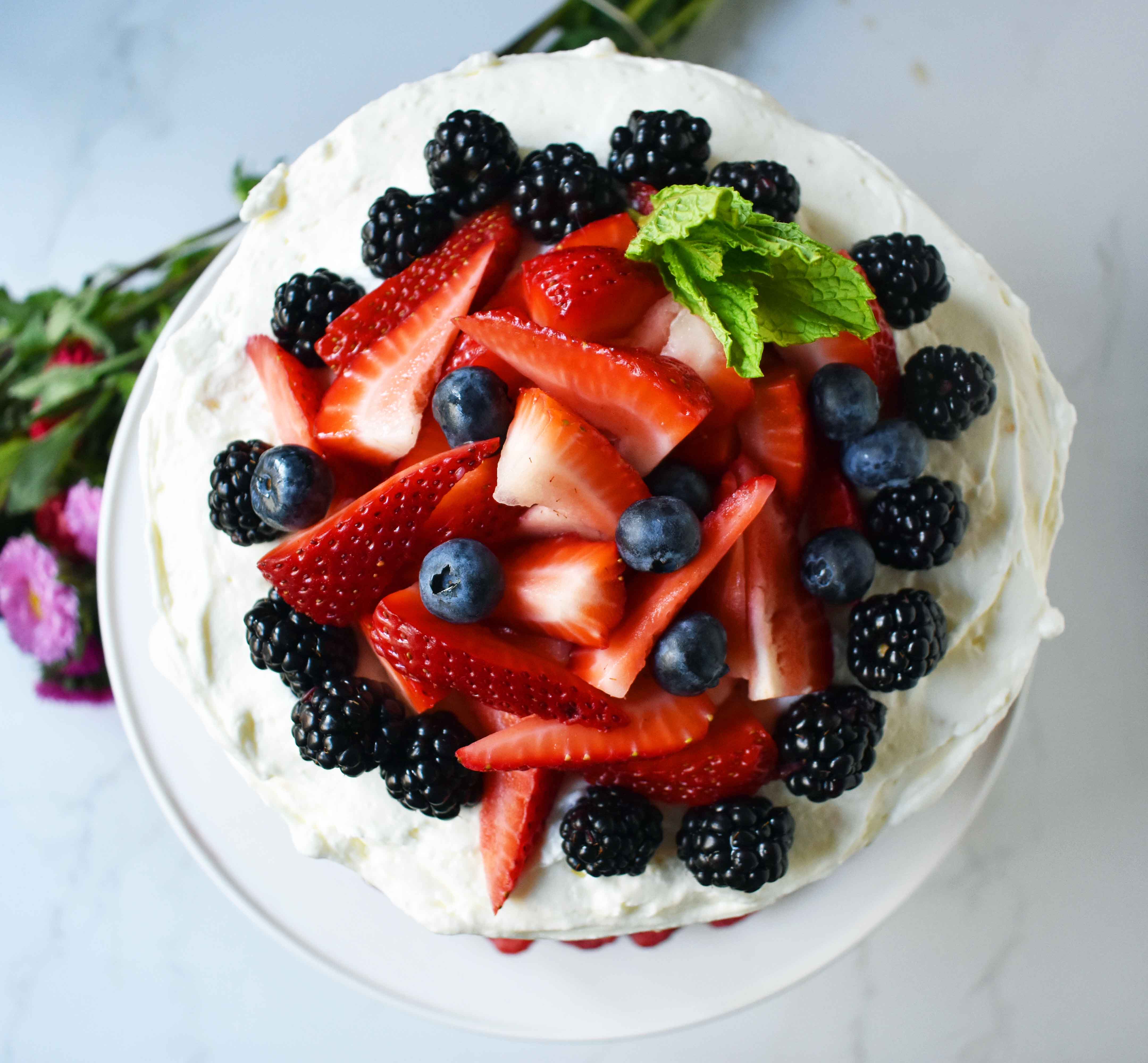 Berry Chantilly Cream Cake. Layers of perfect yellow cake, chantilly cream, jam, and fresh strawberries, raspberries, blackberries, and blueberries. The perfect Spring and Summer dessert that everyone will love. www.modernhoney.com