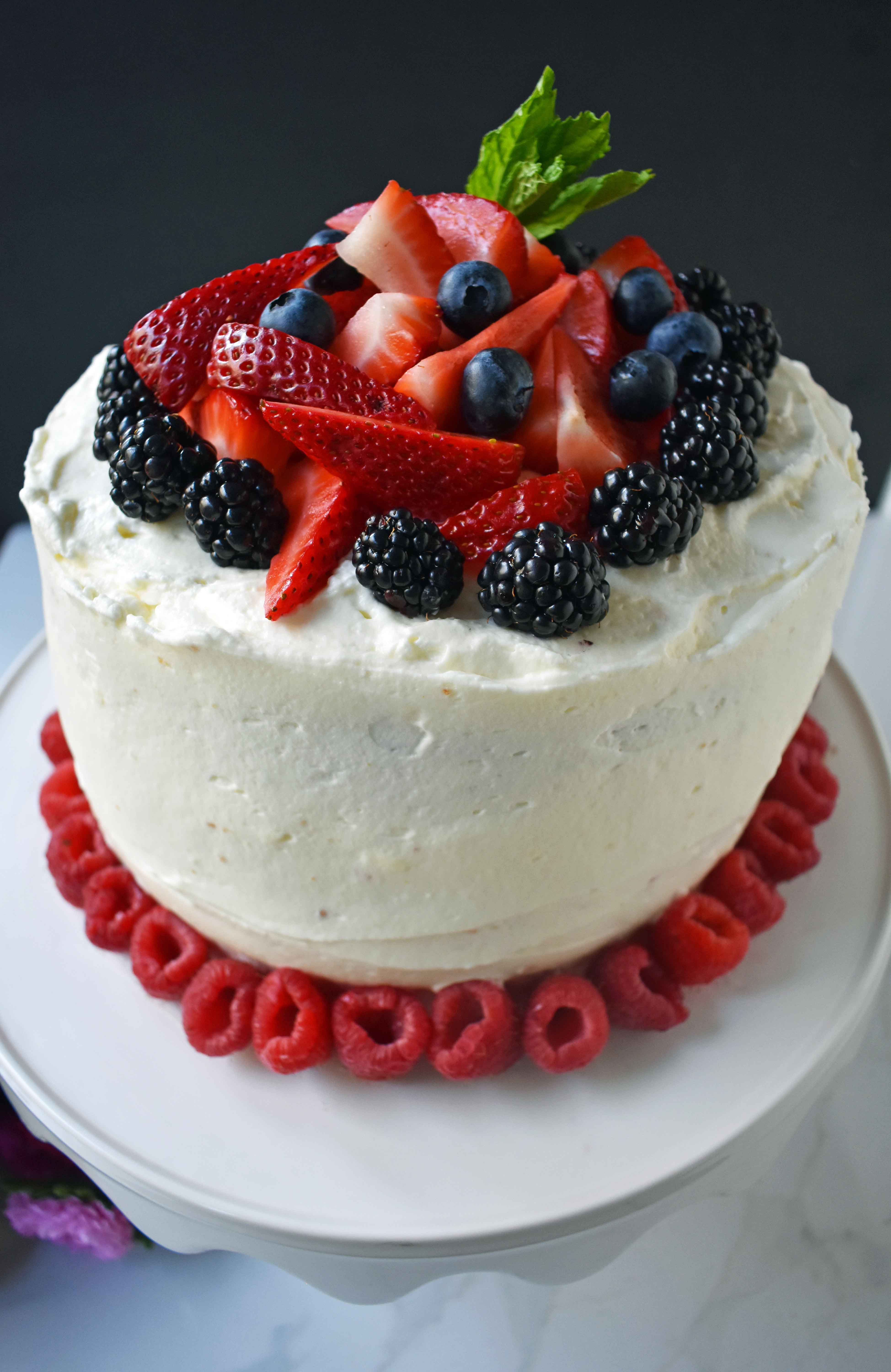 Berry Chantilly Cream Cake. Layers of perfect yellow cake, chantilly cream, jam, and fresh strawberries, raspberries, blackberries, and blueberries. The perfect Spring and Summer dessert that everyone will love. www.modernhoney.com