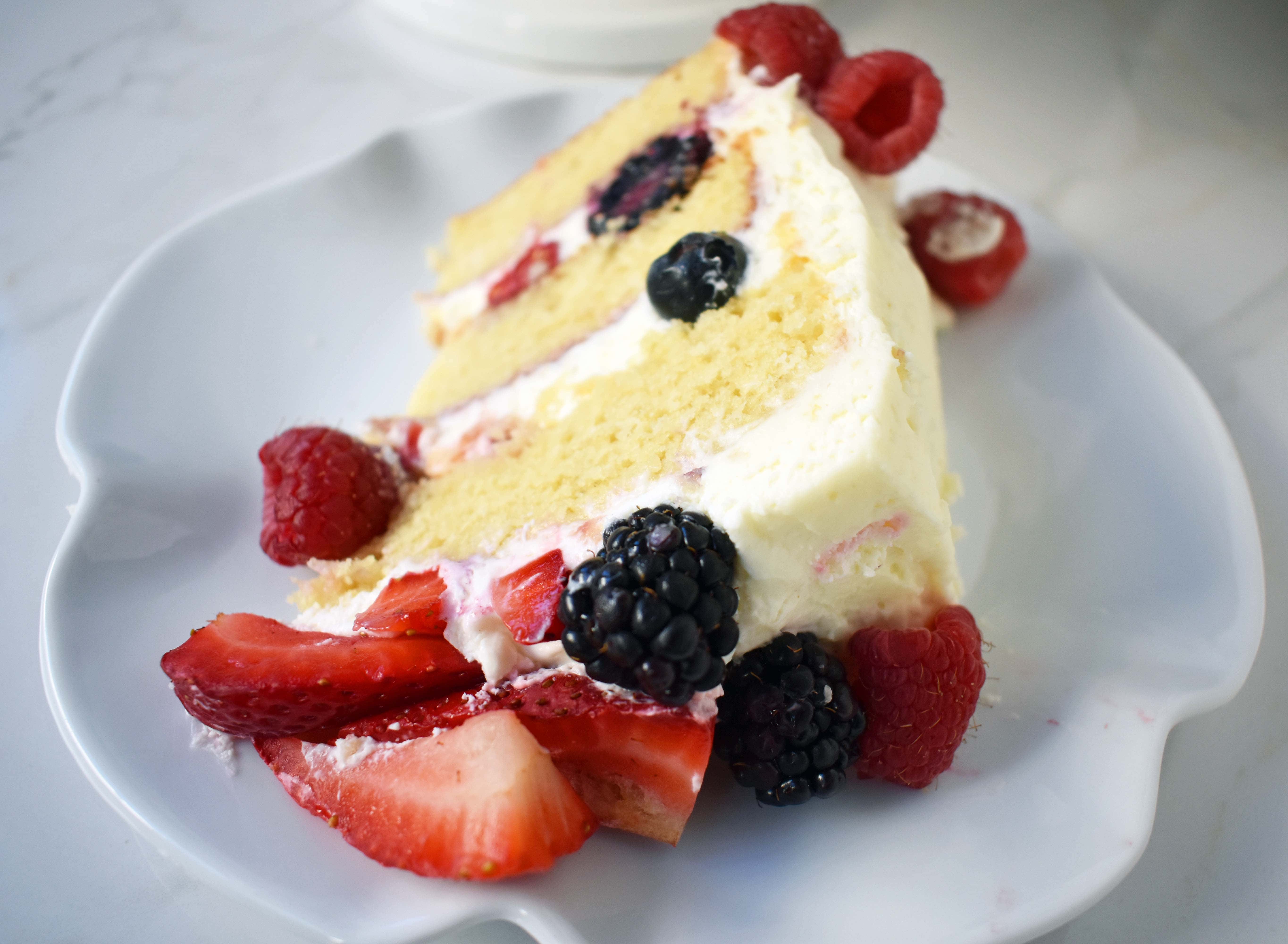 Berry Chantilly Cream Cake. Layers of perfect yellow cake, chantilly cream, jam, and fresh strawberries, raspberries, blackberries, and blueberries. The perfect Spring and Summer dessert that everyone will love. www.modernhoney.com