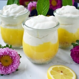 Lemon Cream Parfait Pie Jars. Homemade lemon curd layered with graham or butter cookie crust and sweetened cream cheese and whipped cream. The perfect dessert for parties, Mother's Day, Spring, or Summer parties. It's a lemon cream pie in a jar. Also, tips on how to make it into a 9 inch lemon cream pie. www.modernhoney.com
