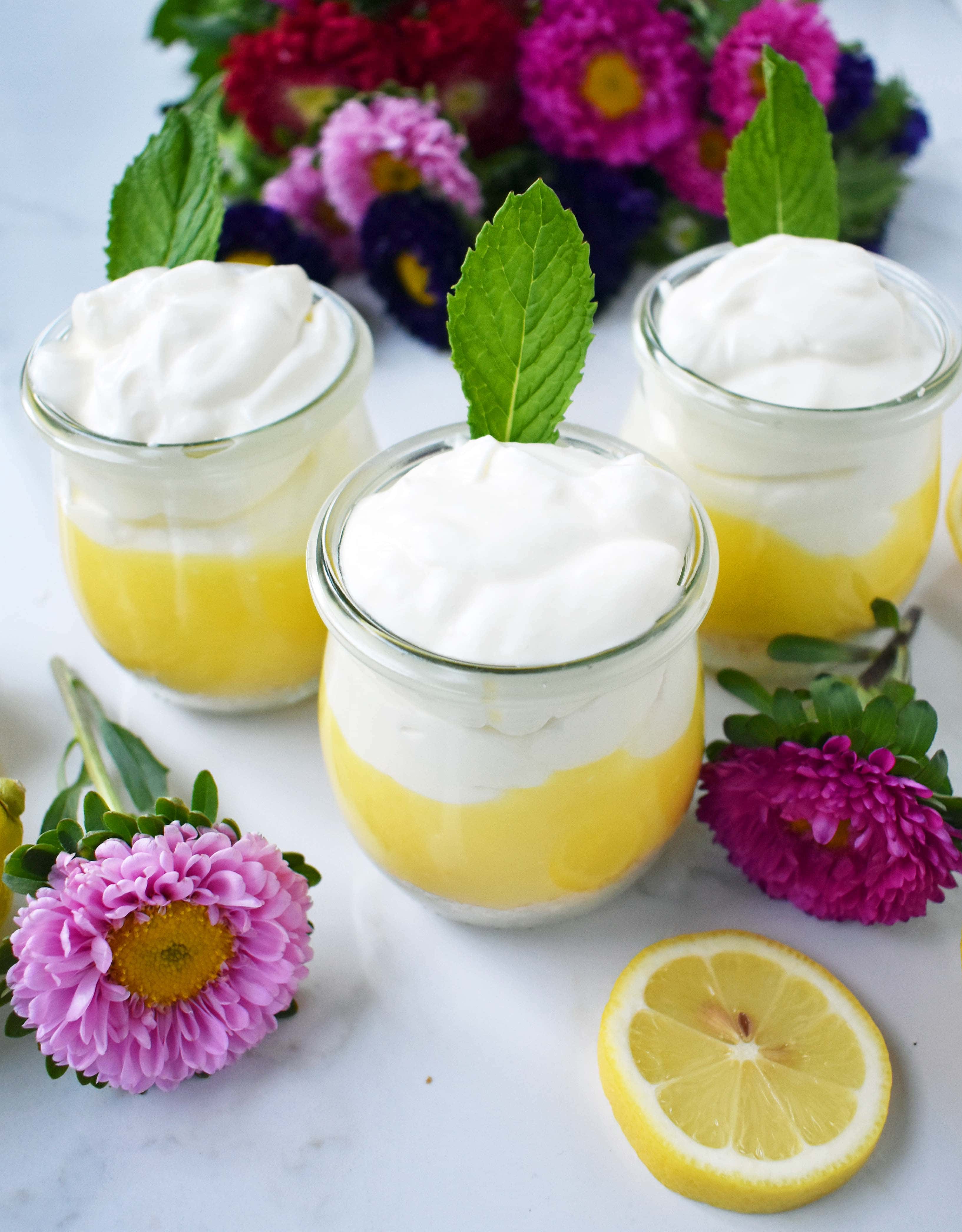 Lemon Cream Parfait Pie Jars. Homemade lemon curd layered with graham or butter cookie crust and sweetened cream cheese and whipped cream. The perfect dessert for parties, Mother's Day, Spring, or Summer parties. It's a lemon cream pie in a jar. Also, tips on how to make it into a 9 inch lemon cream pie. www.modernhoney.com