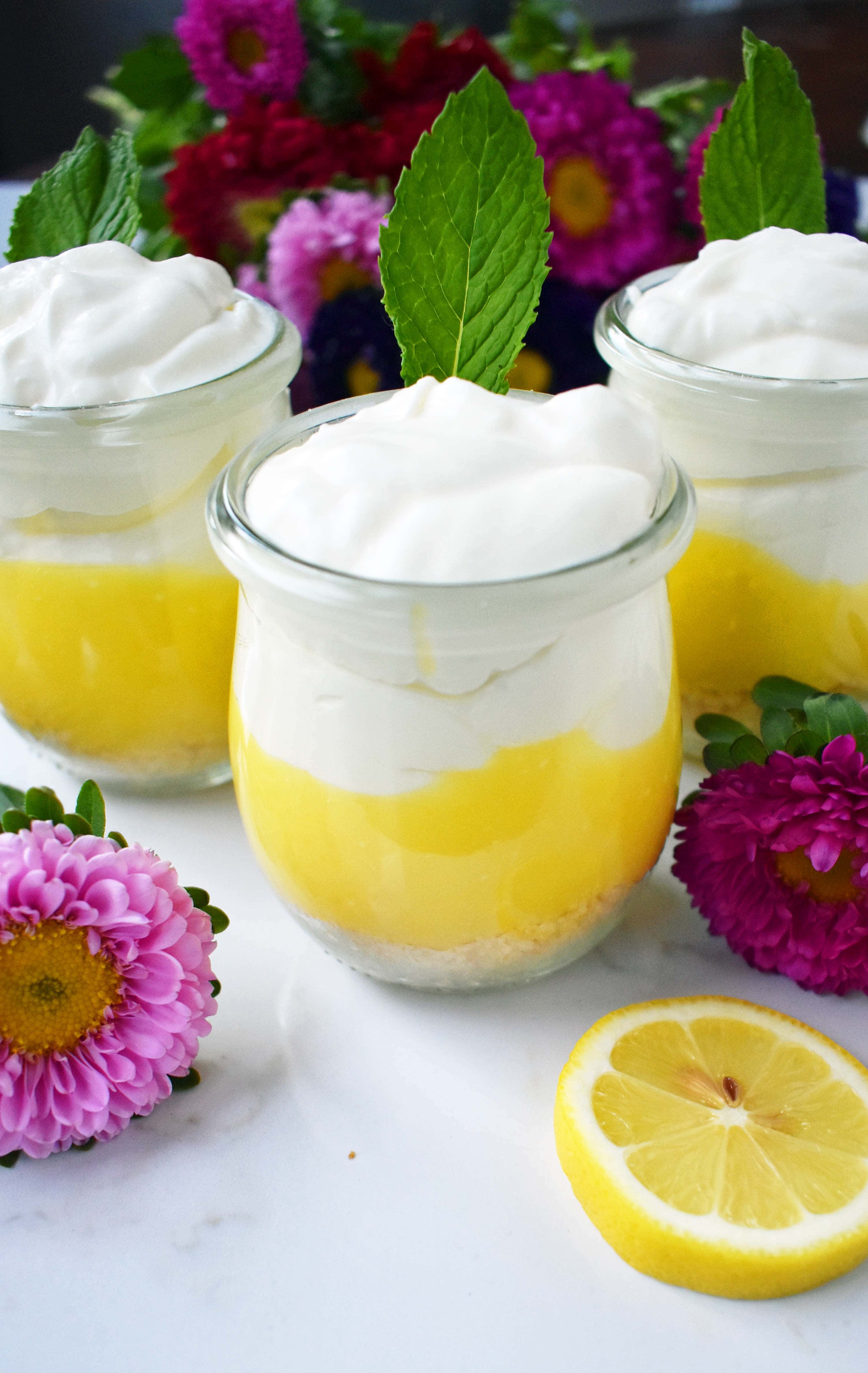 Lemon Cream Parfait Pie Jars. Homemade lemon curd layered with graham or butter cookie crust and sweetened cream cheese and whipped cream. The perfect dessert for parties, Mother's Day, Spring, or Summer parties. It's a lemon cream pie in a jar. Also, tips on how to make it into a 9 inch lemon cream pie. www.modernhoney.com