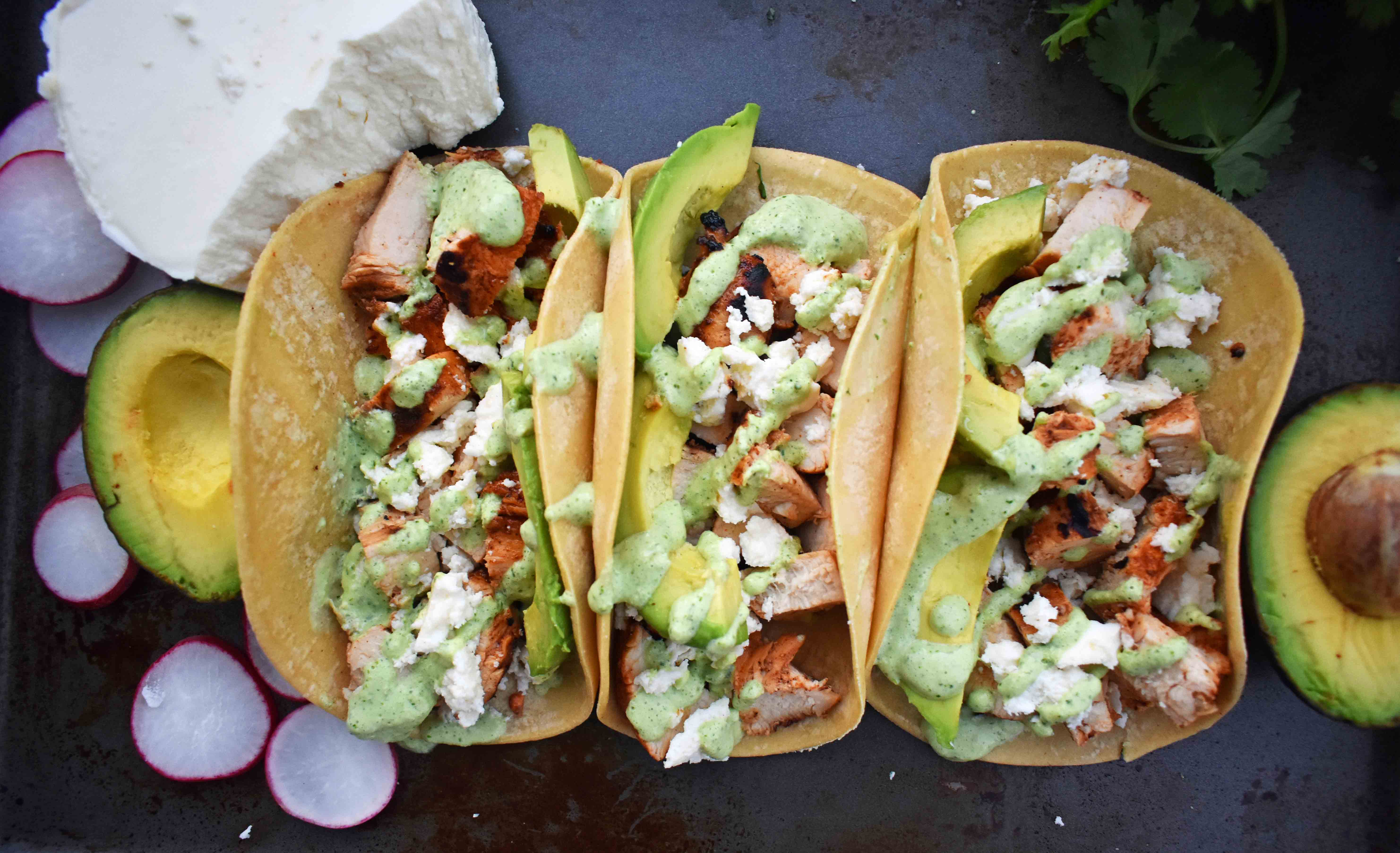 Grilled Chicken Tacos with Roasted Poblano Crema. Chili lime marinated chicken tacos topped with roasted poblano cream sauce, queso fresco cheese, and fresh avocado. www.modernhoney.com