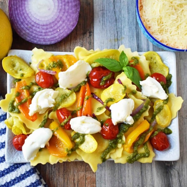 Summer Roasted Vegetable Pesto Ravioli by Modern Honey. This light and fresh summer pasta dish is made with fresh ravioli, tender roasted vegetables, basil pesto sauce, and a touch of mascarpone cheese. A vibrant and healthy pasta dish. www.modernhoney.com