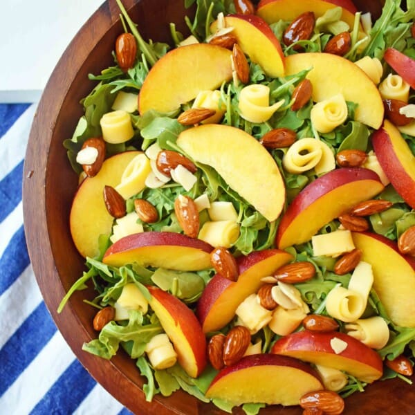 Peach Gouda Honey Almond Salad. Arugula, Creamy Gouda Cheese, Sweet Peaches or Nectarines, and Honey Glazed Almonds tossed with a Sweet Honey Dressing. www.modernhoney.com