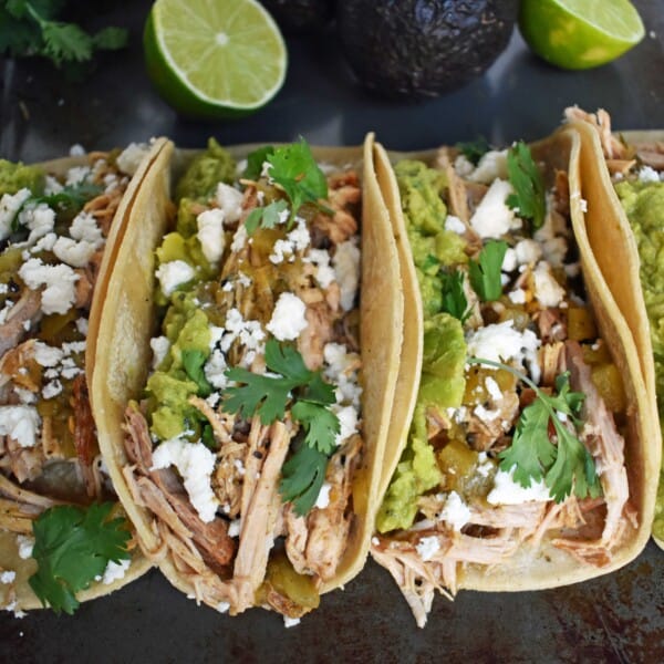 Green Chili Pork Carnitas Tacos. Slow cooked green chili pork seasoned with Mexican spices and freshly squeezed lime juice placed in a hot corn tortilla and topped with cotija cheese, jalapenos, avocado and cilantro. www.modernhoney.com