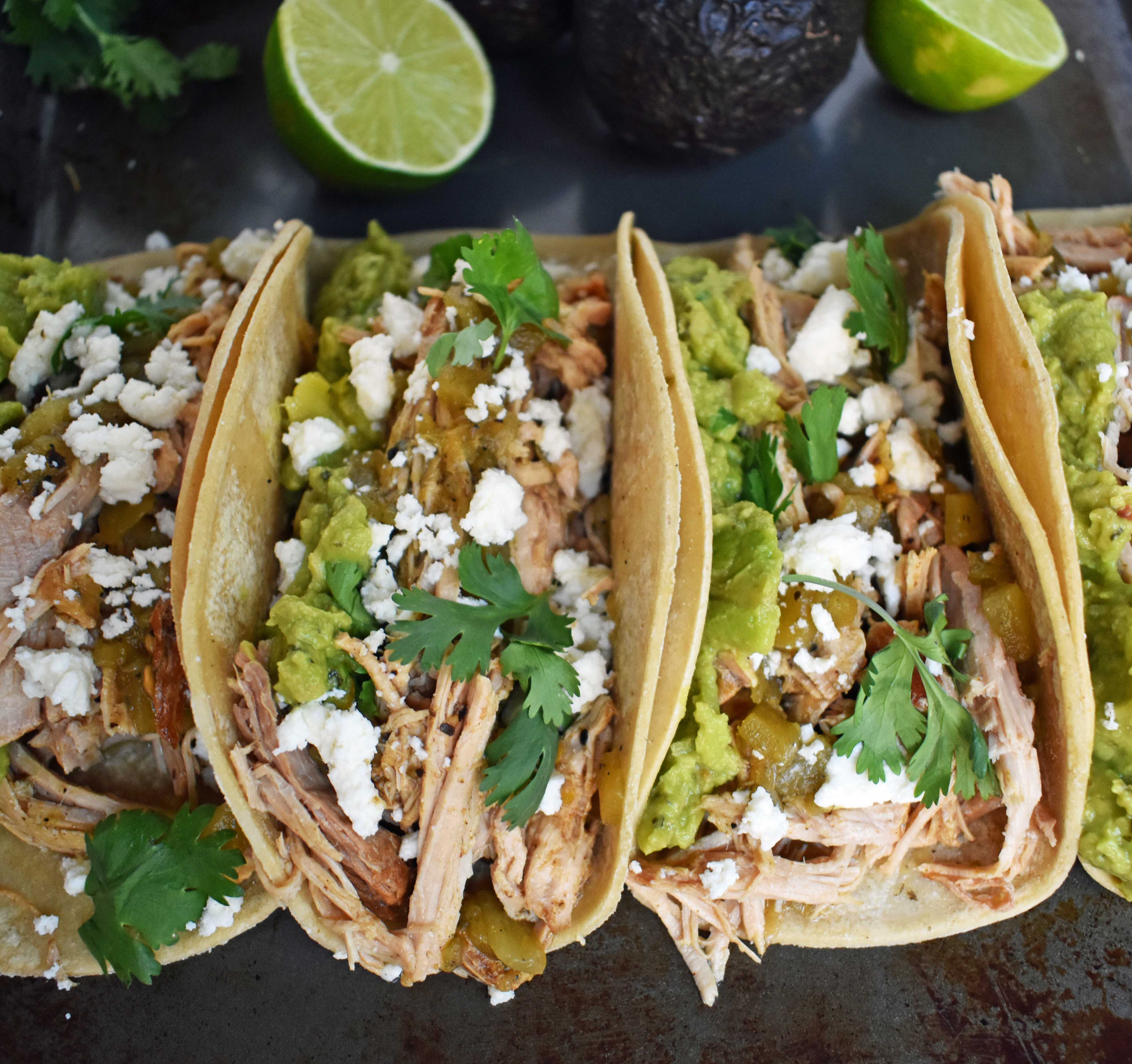 Green Chili Pork Carnitas Tacos. Slow cooked green chili pork seasoned with Mexican spices and freshly squeezed lime juice placed in a hot corn tortilla and topped with cotija cheese, jalapenos, avocado and cilantro. www.modernhoney.com