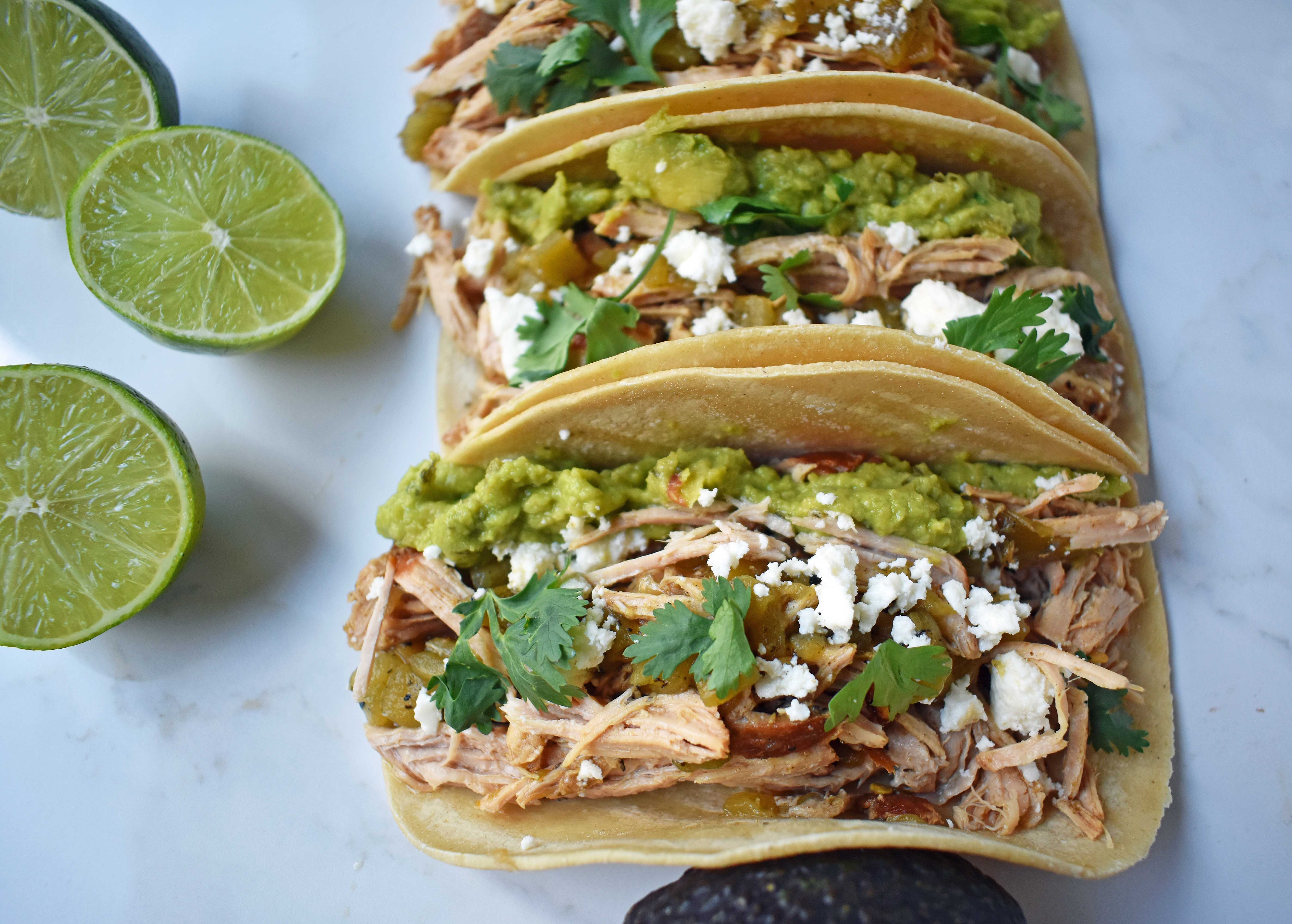 Green Chili Pork Carnitas Tacos. Slow cooked green chili pork seasoned with Mexican spices and freshly squeezed lime juice placed in a hot corn tortilla and topped with cotija cheese, jalapenos, avocado and cilantro. www.modernhoney.com