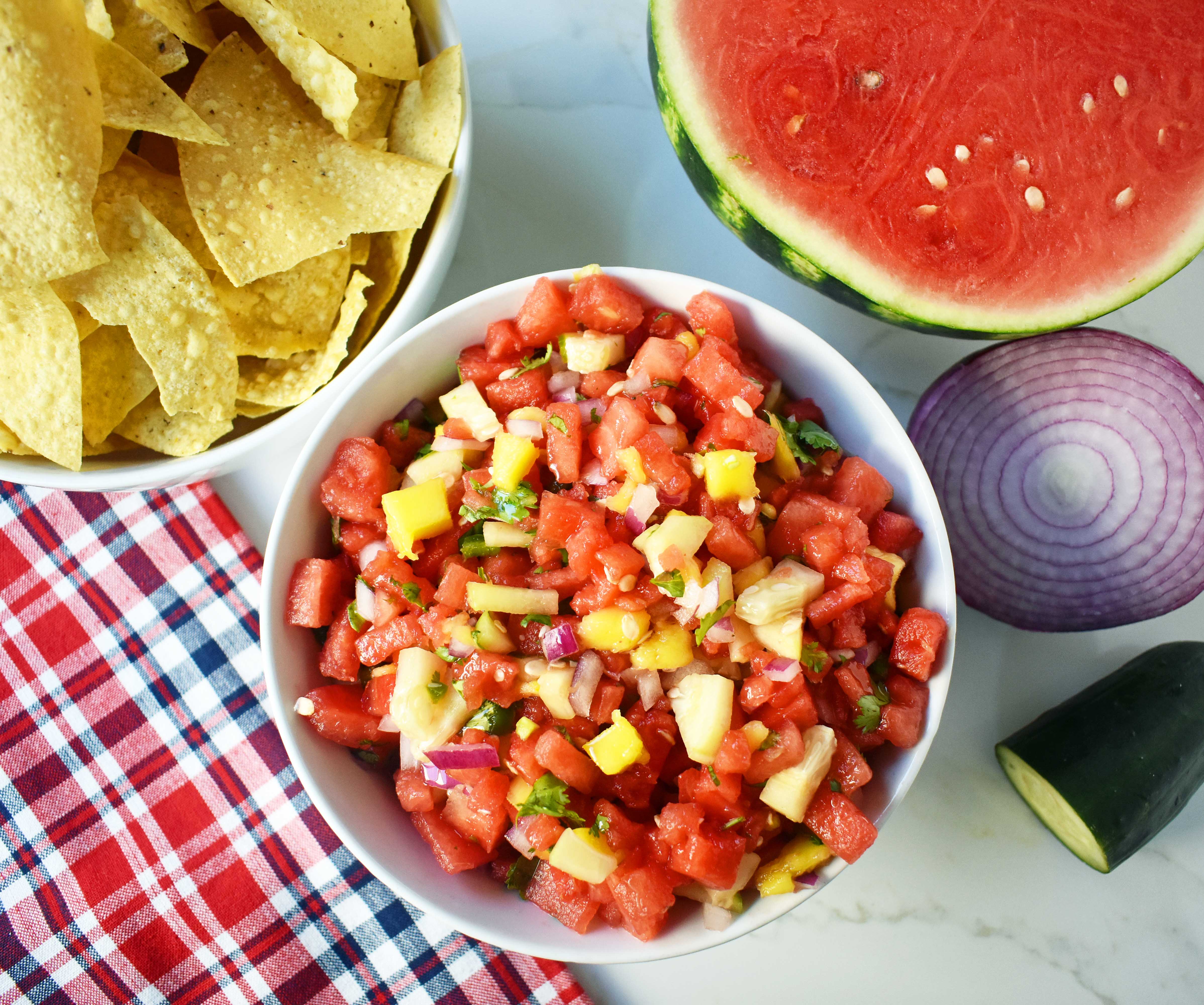 Watermelon Mango Salsa made with fresh watermelon, sweet mango, crisp cucumber, red onion, cilantro, jalapeno and a touch of honey. A sweet and spicy summer salsa. www.modernhoney.com