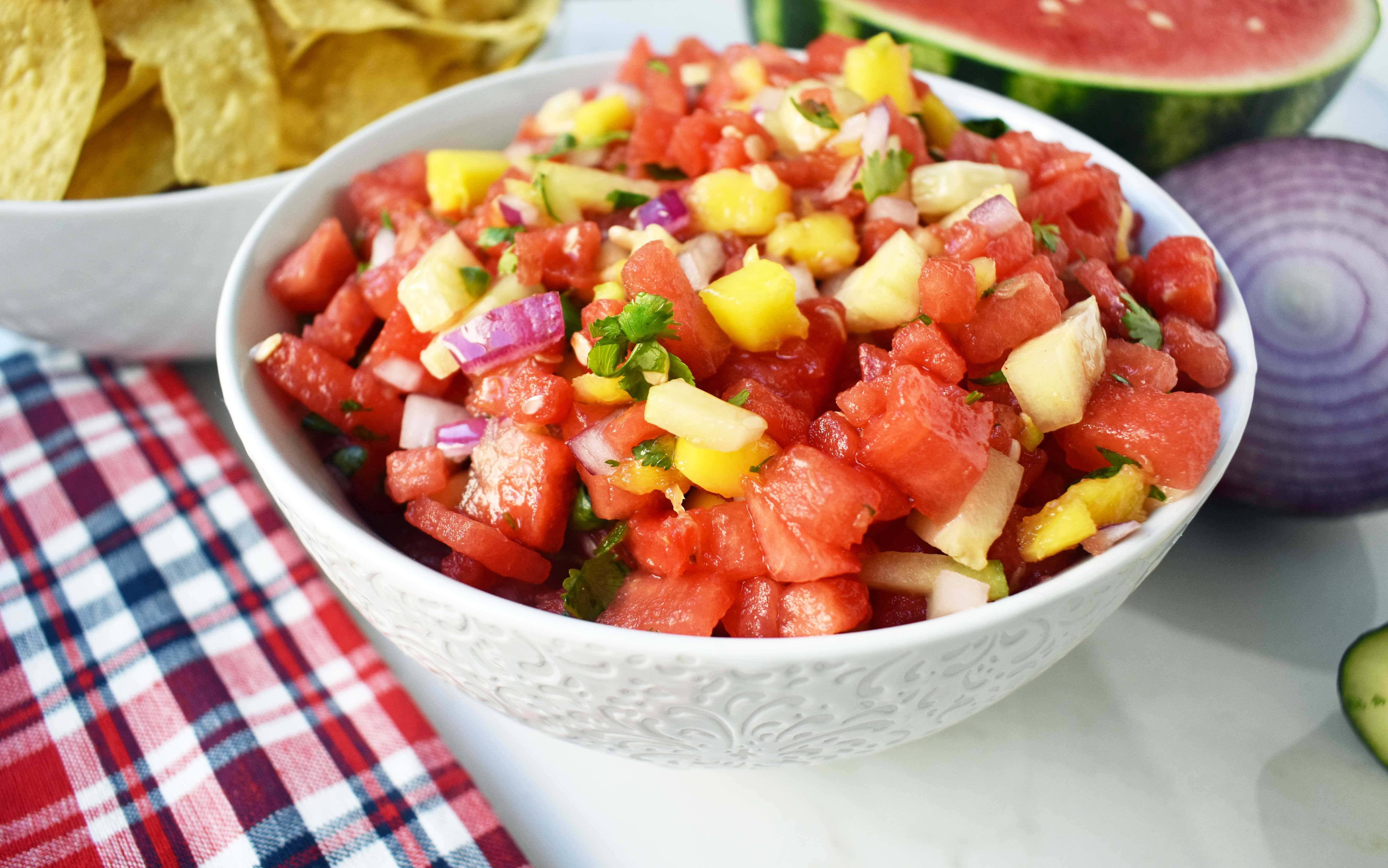 Watermelon Mango Salsa made with fresh watermelon, sweet mango, crisp cucumber, red onion, cilantro, jalapeno and a touch of honey. A sweet and spicy summer salsa. www.modernhoney.com